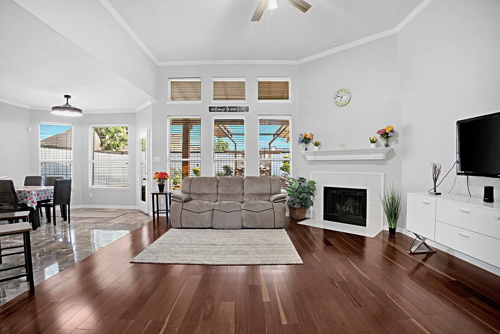 Rich wood-finish flooring extends throughout this open-concept space