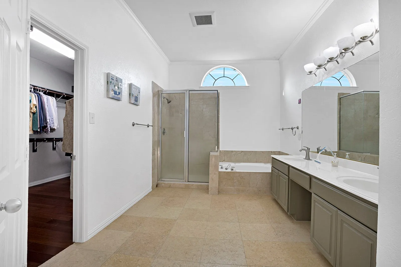 Wood-finish flooring throughout, complemented by light blue walls and white trim