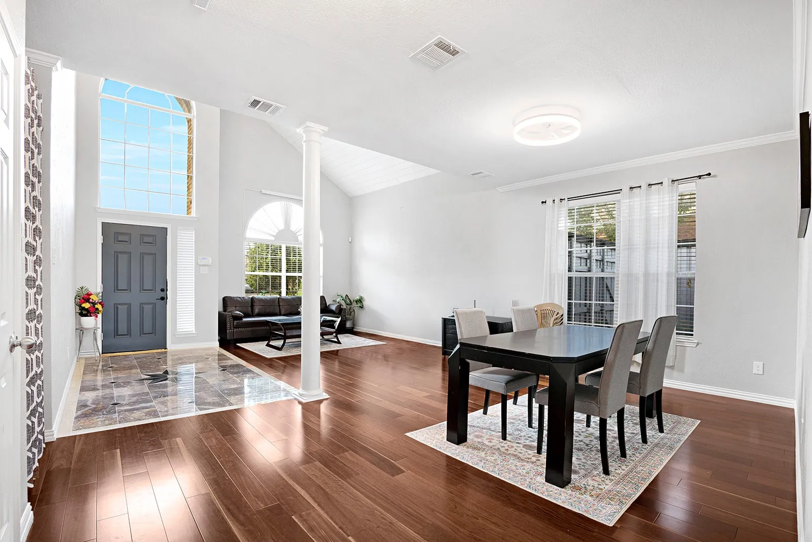 Open living area featuring wood-finish flooring, recessed lighting, and a paneled ceiling