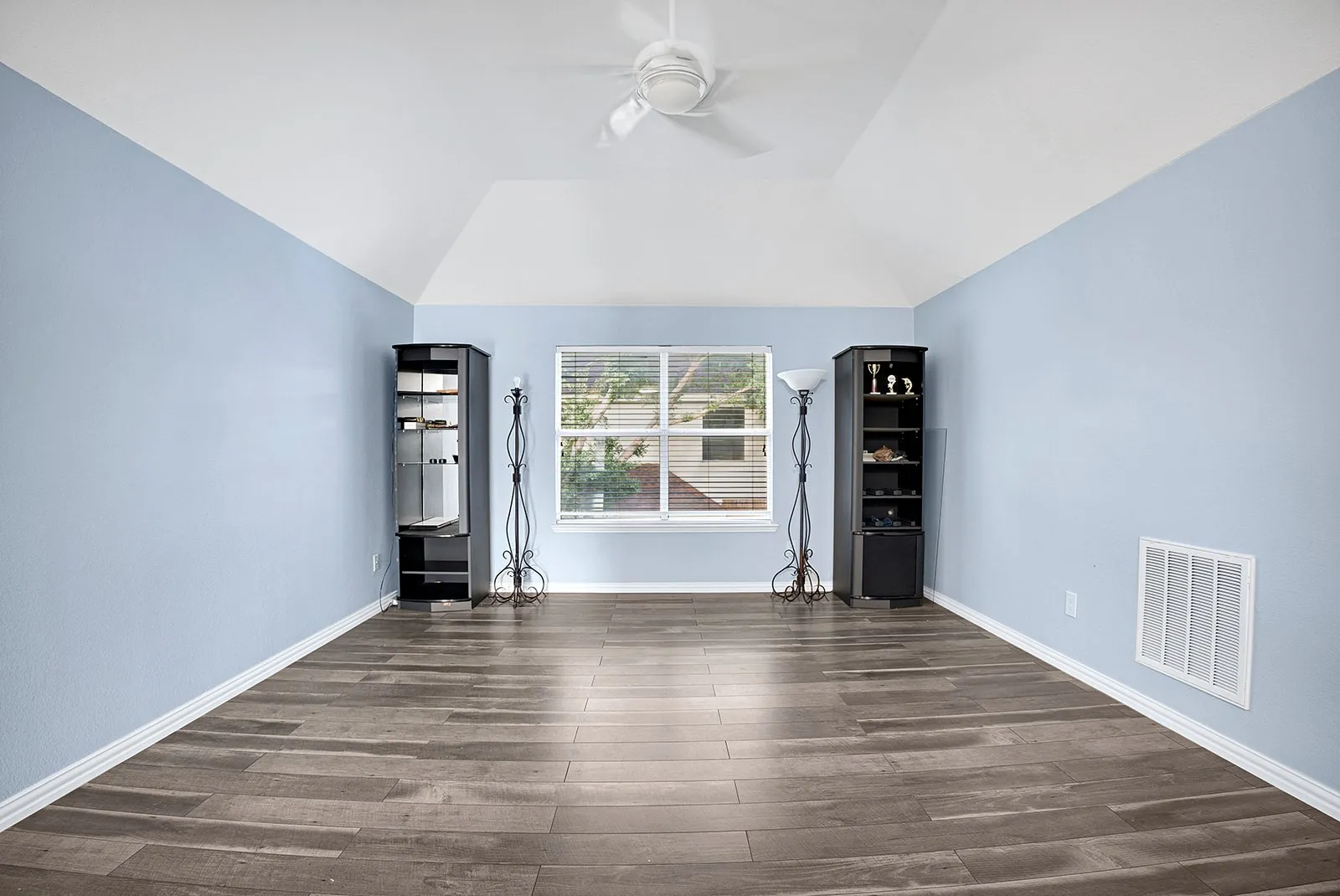 Bright room featuring wood-finish flooring and light gray walls
