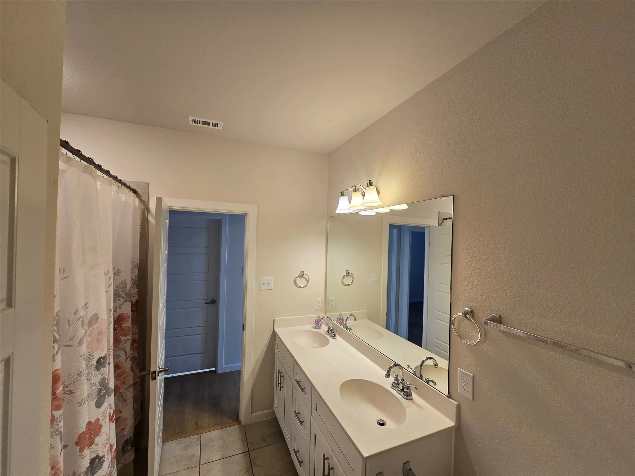 Dual vanity with integrated sinks and chrome fixtures