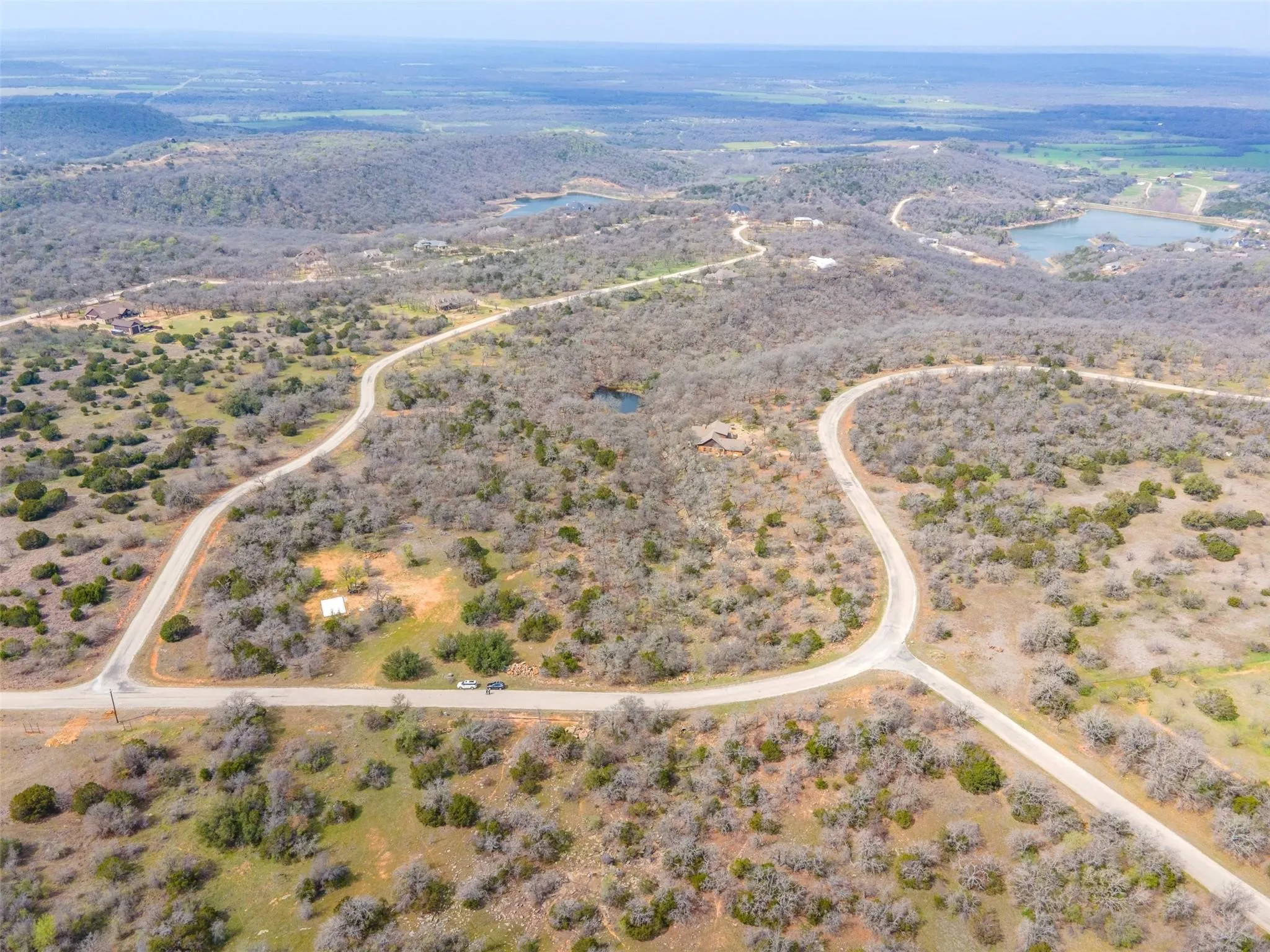 Aerial view of 2.87-acre corner lot in The Ranches at Clayton Mountain, Gordon TX, showing flat building area, gully, and small stream
