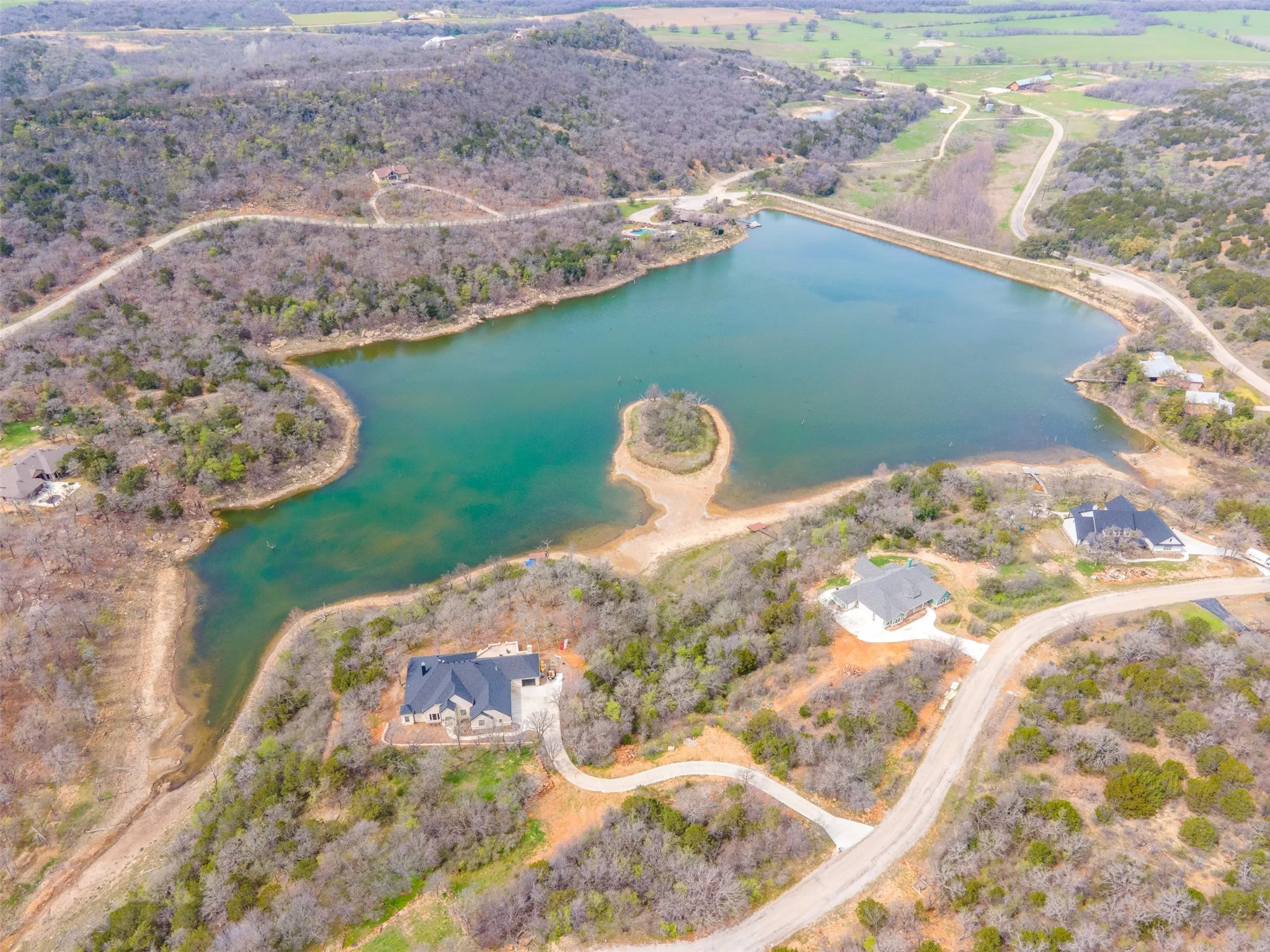Overhead perspective of property near The Cove at Lake McIntire with clubhouse, pool, fishing pier, and boating