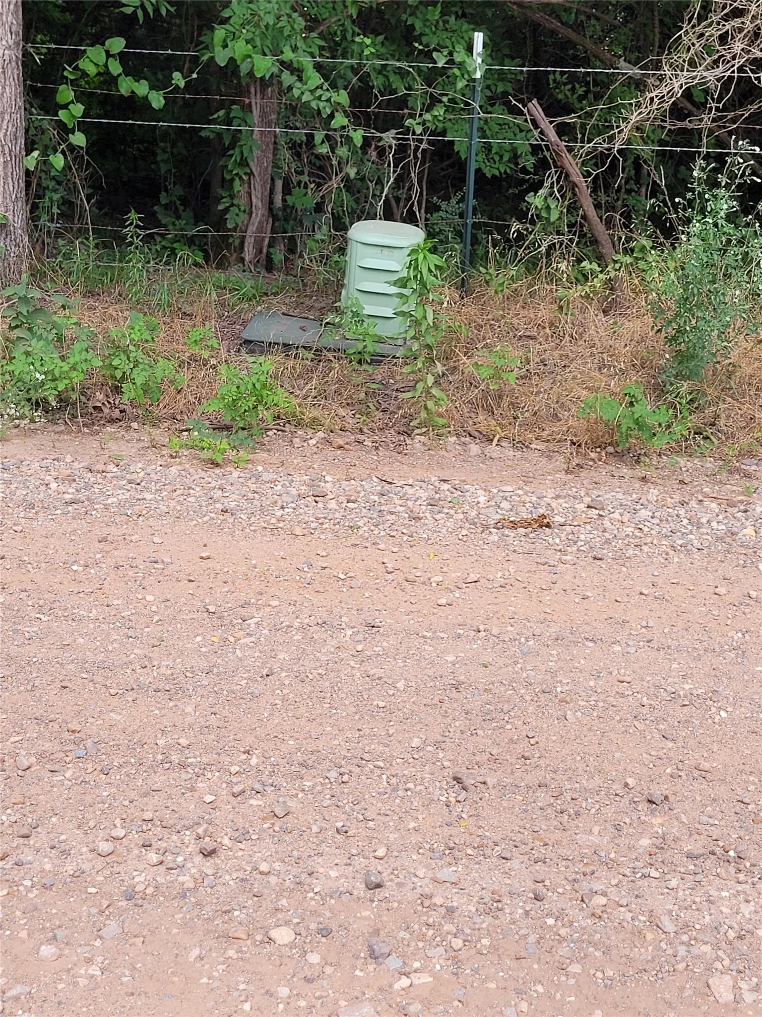 across road from west boundary post appears is fiber optic telephone line.