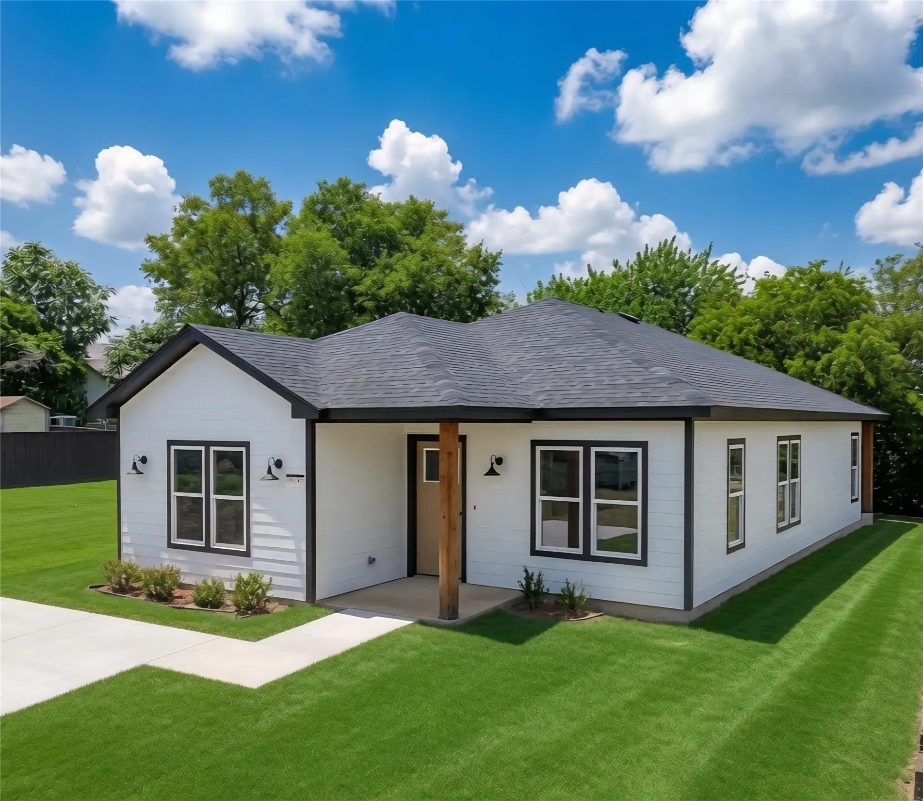 Modern single-story home featuring a dark shingle roof and contrasting white siding with black trim