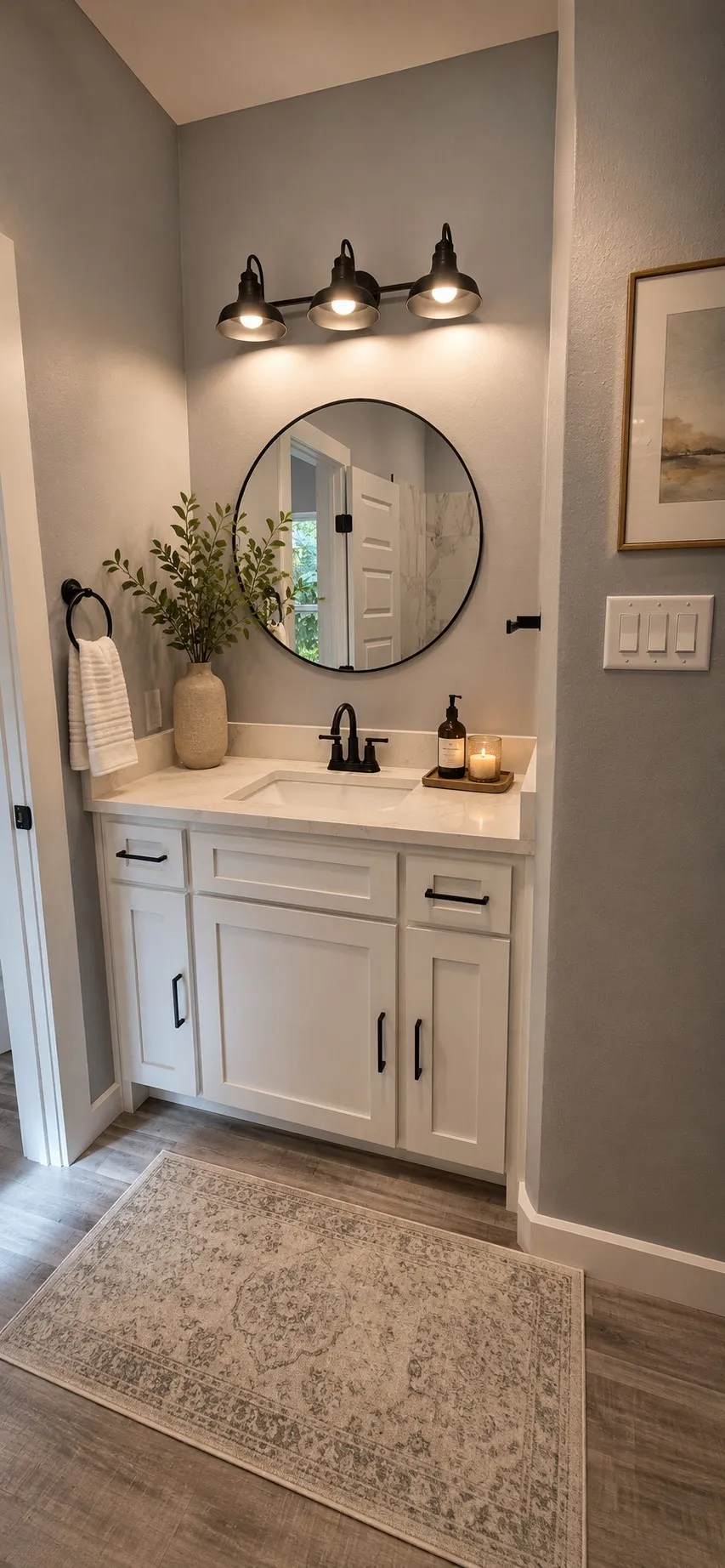 Bathroom vanity with white cabinetry, matte black hardware, and a light-toned countertop