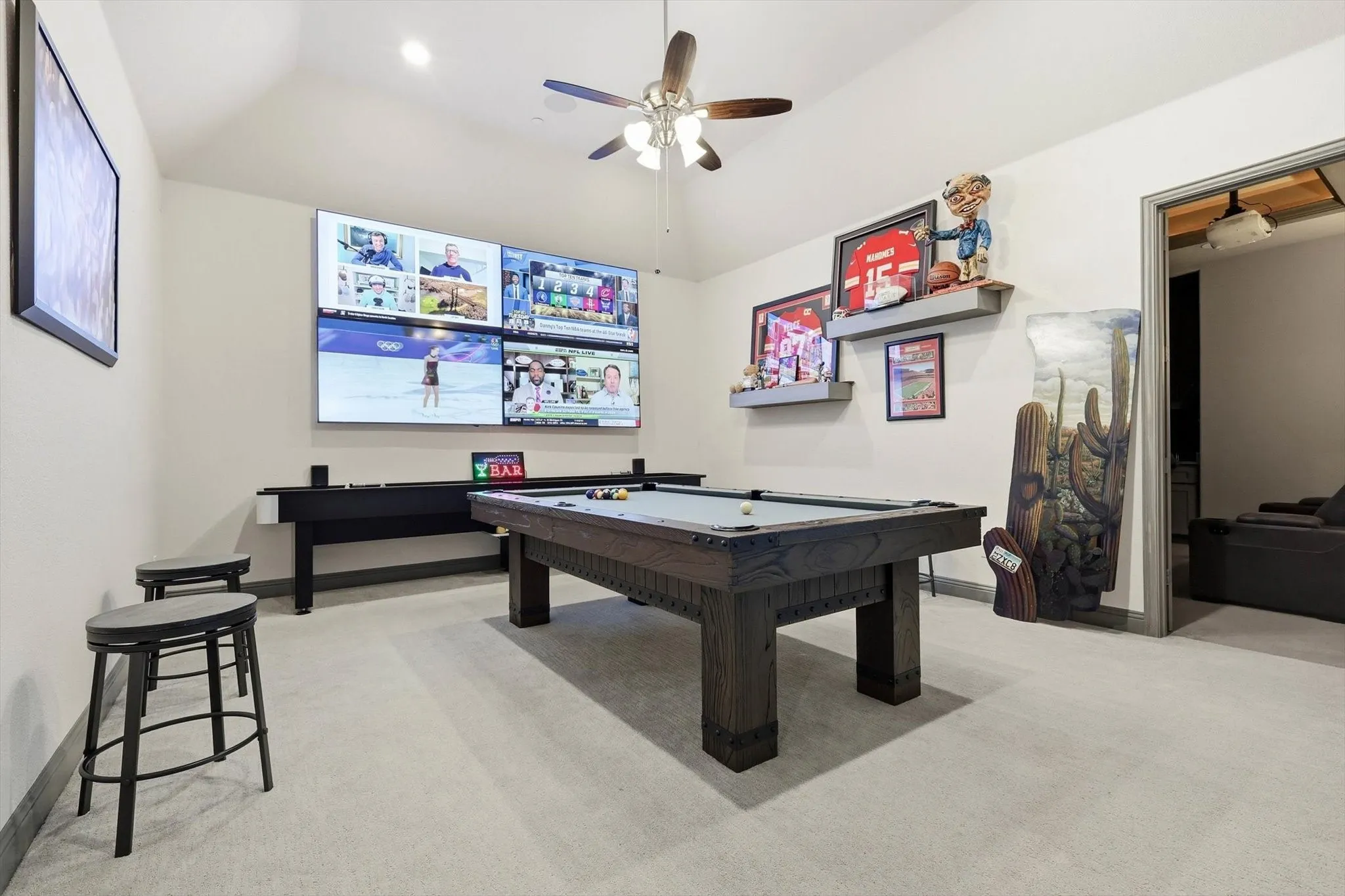 Vaulted ceiling game room featuring light gray carpeting and a ceiling fan