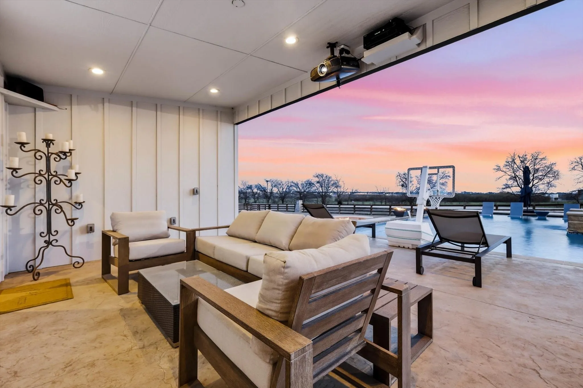 Covered patio featuring recessed lighting, a ceiling-mounted projector, and concrete flooring