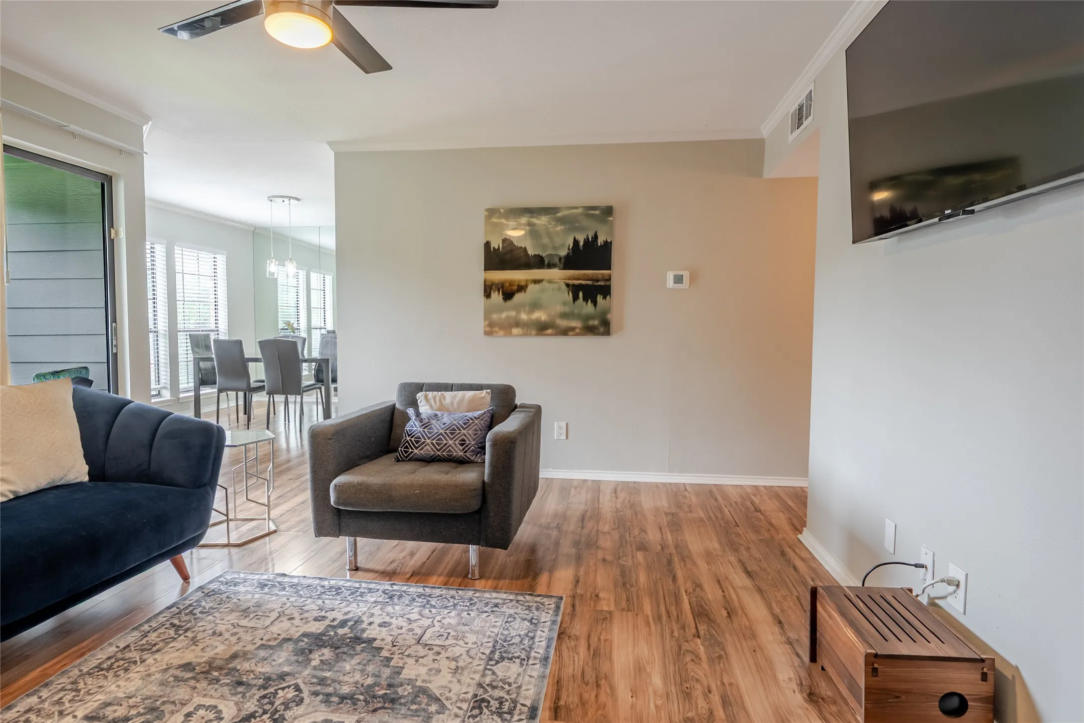 Living area with wood-finish flooring and light neutral wall paint