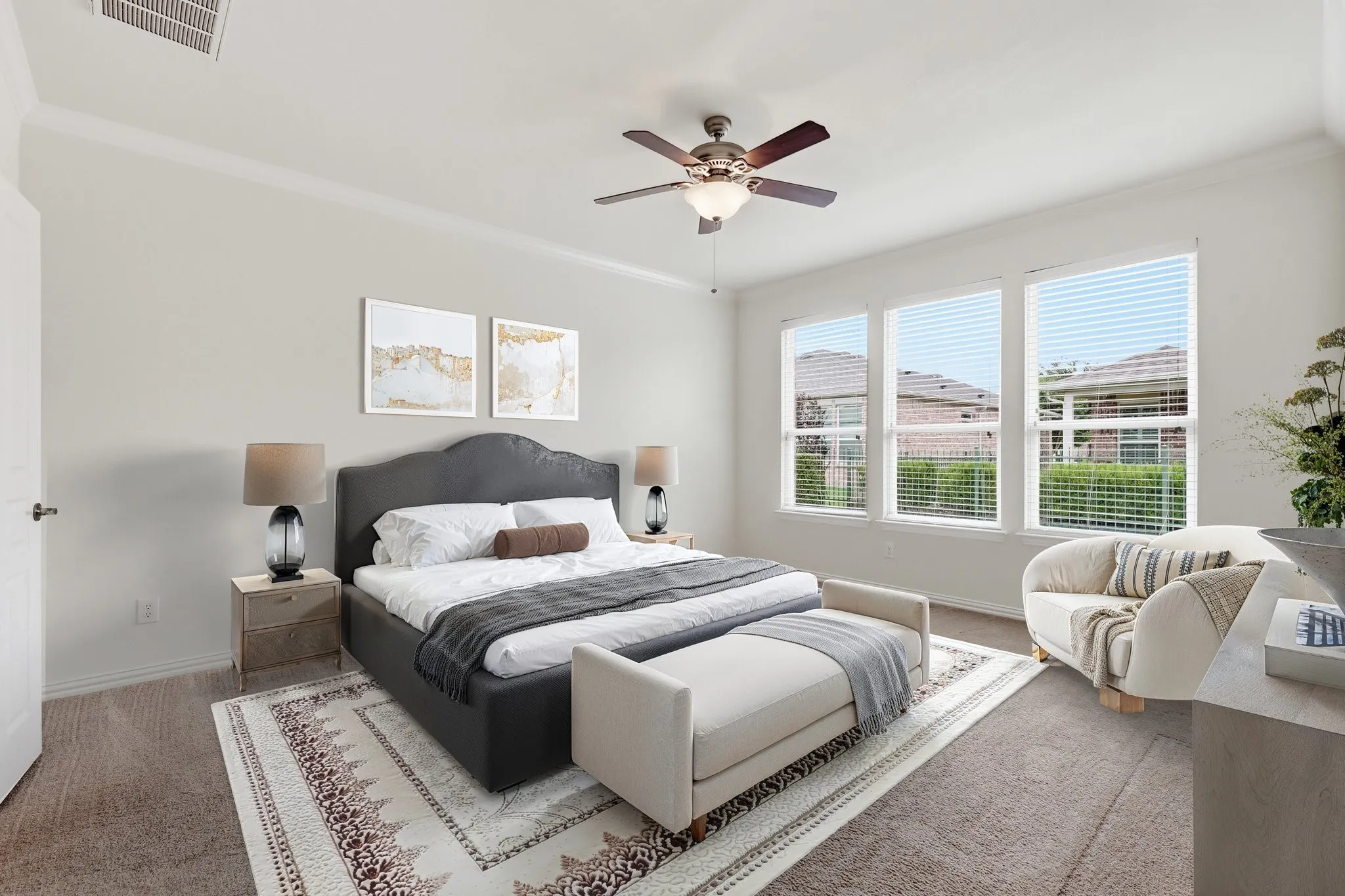 Staged Bedroom with neutral-toned walls, crown molding, and carpeting