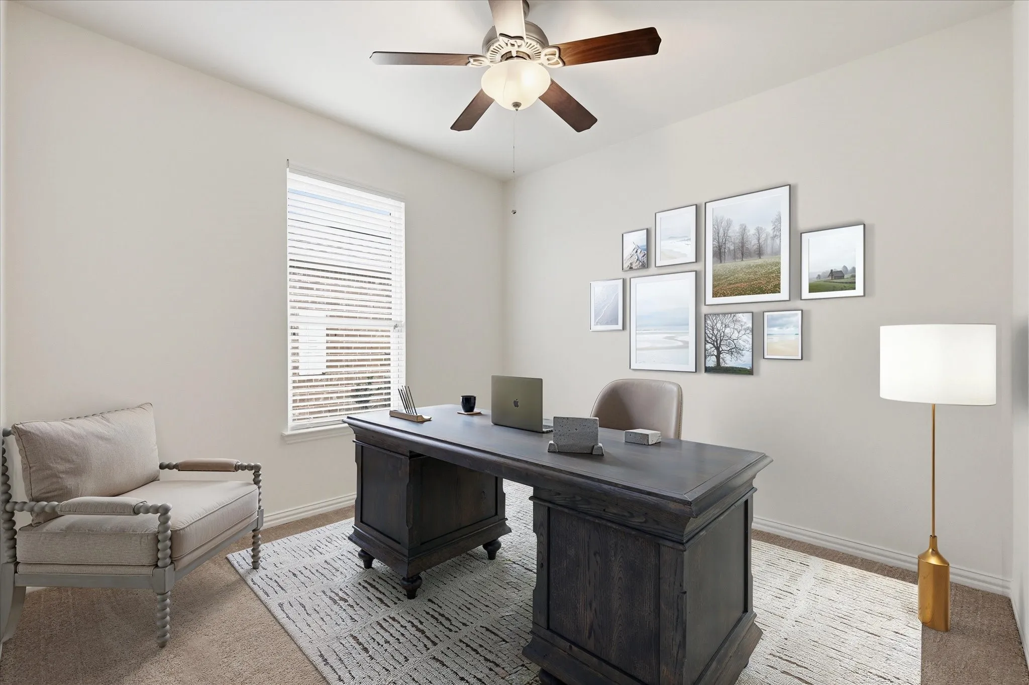 Staged office room with a ceiling fan featuring integrated lighting, a window with horizontal blinds, and baseboard molding
