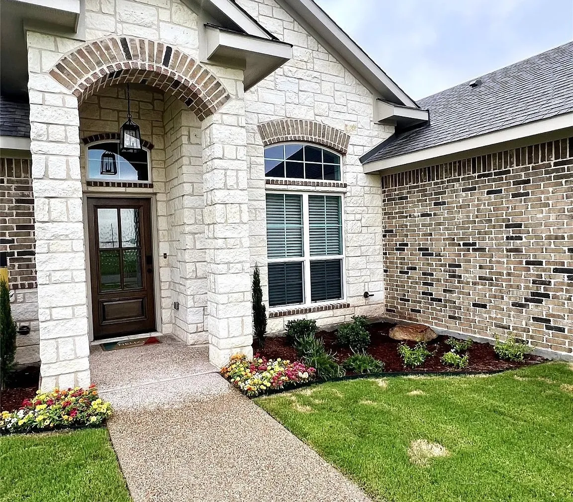 Stone and brick exterior with an arched entryway