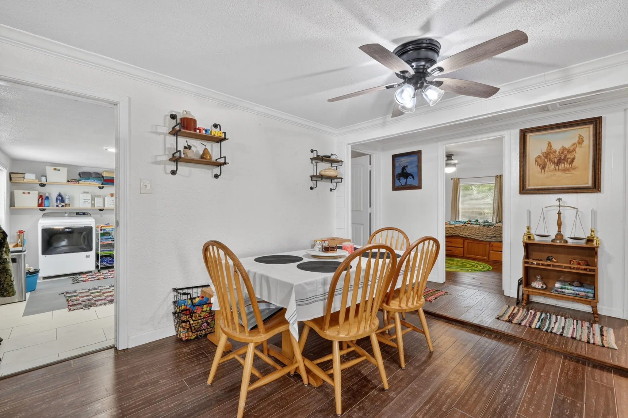 Dining area featuring wood-finish flooring and a ceiling fan with integrated lighting