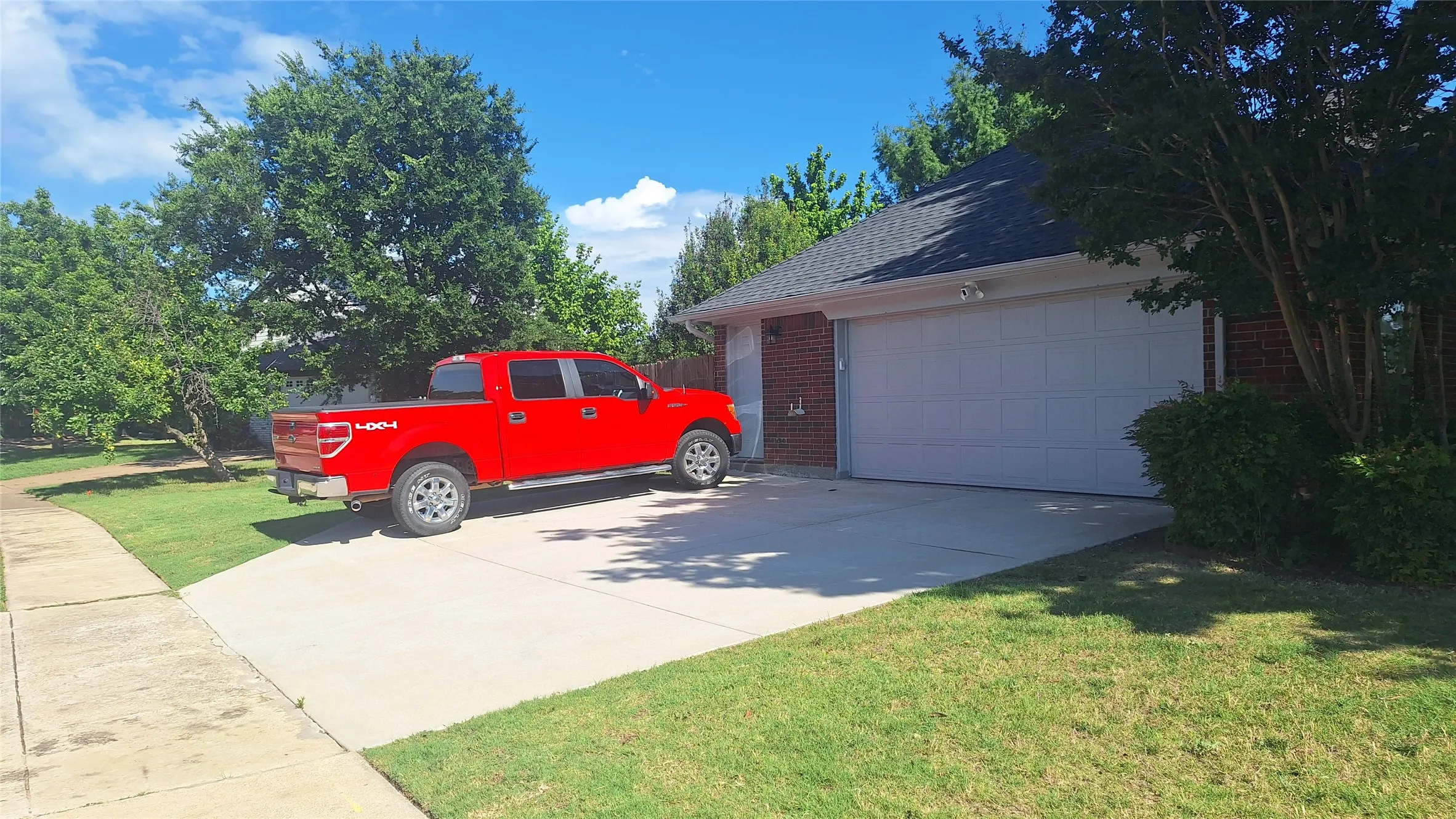 Bear Creek side driveway with 3rd car pad & passage door into garage, 6x9 workbench or golf cart parking alcove