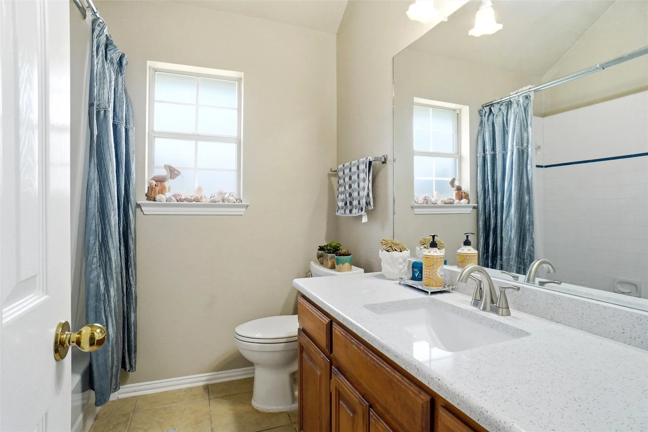 7x7 spacious hall bath with dual quartz vanities, linen closet, new faucets and vanity light