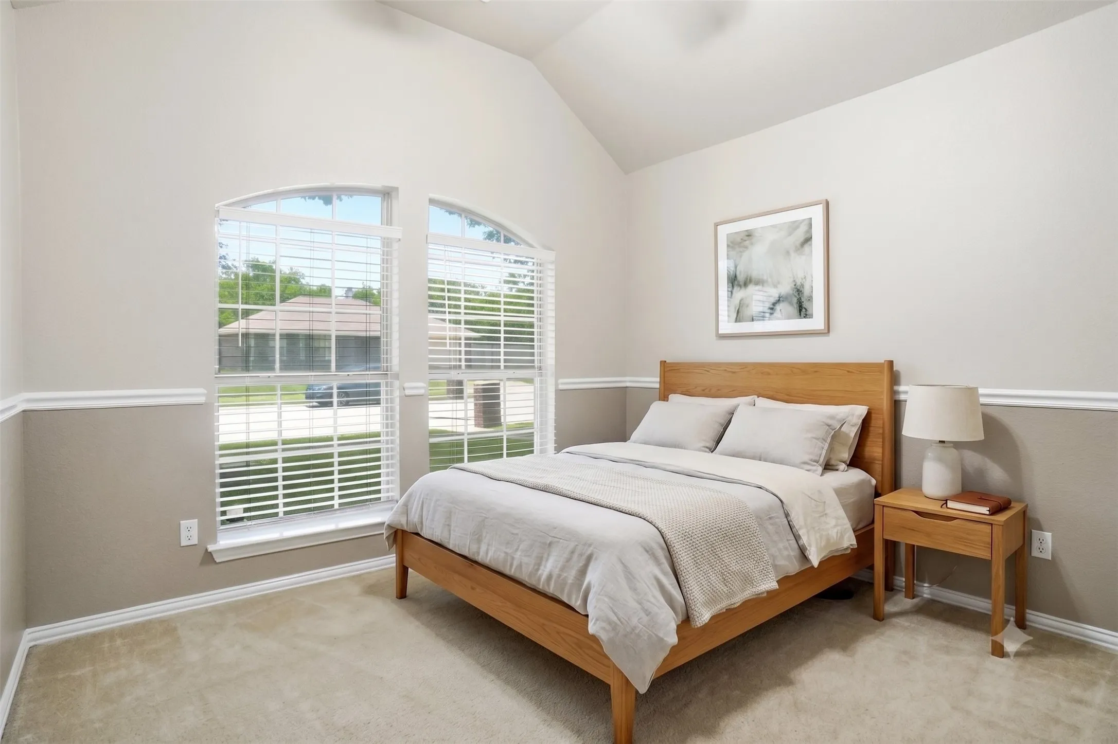 Bedroom 2 with vaulted 12 ft ceiling,  fan, chair rail accent and full wall closet