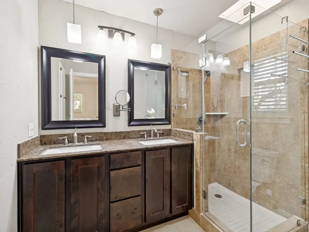 Skylight above travertine tiled shower