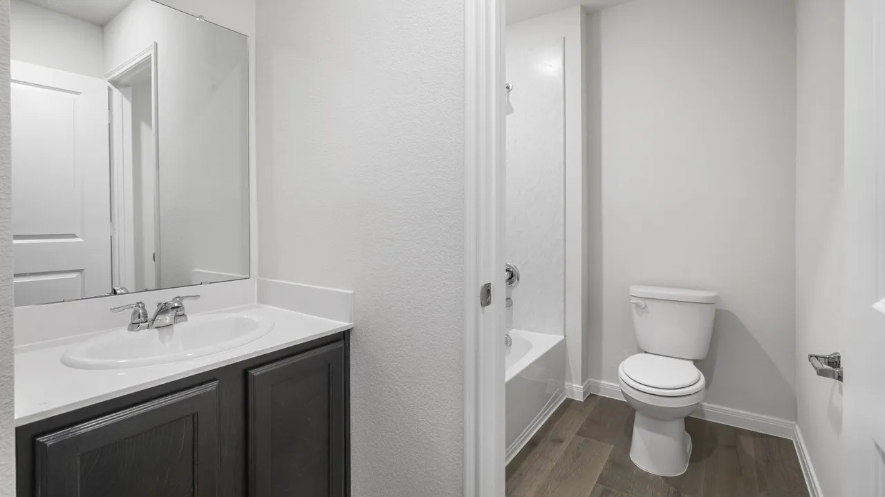 Bathroom featuring a vanity with dark wood-finish cabinetry, a white countertop, and an undermount sink