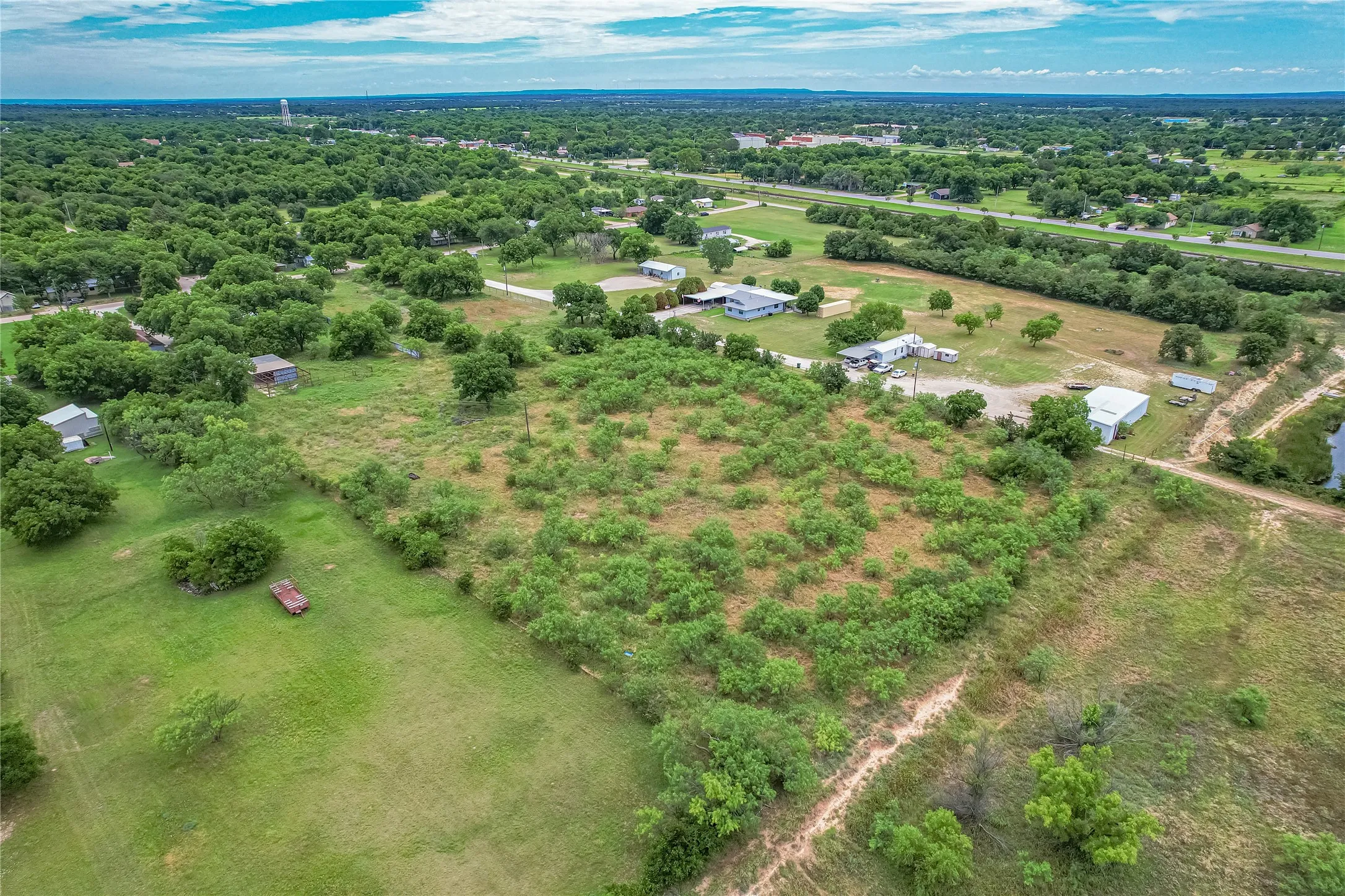 Expansive parcel featuring a mix of cleared land and natural vegetation