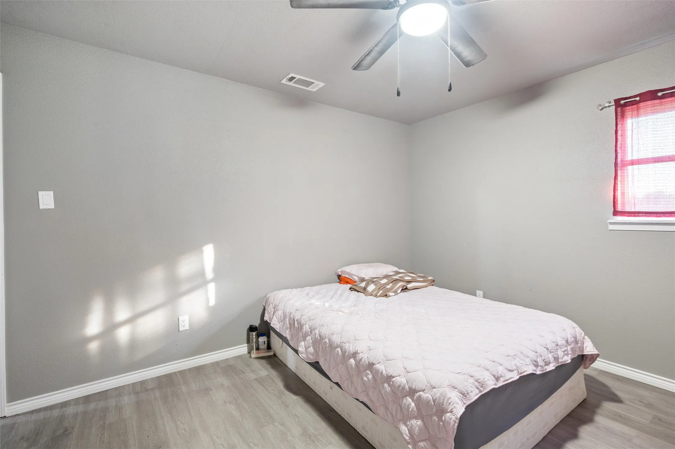 Neutral gray walls complement wood-finish flooring
