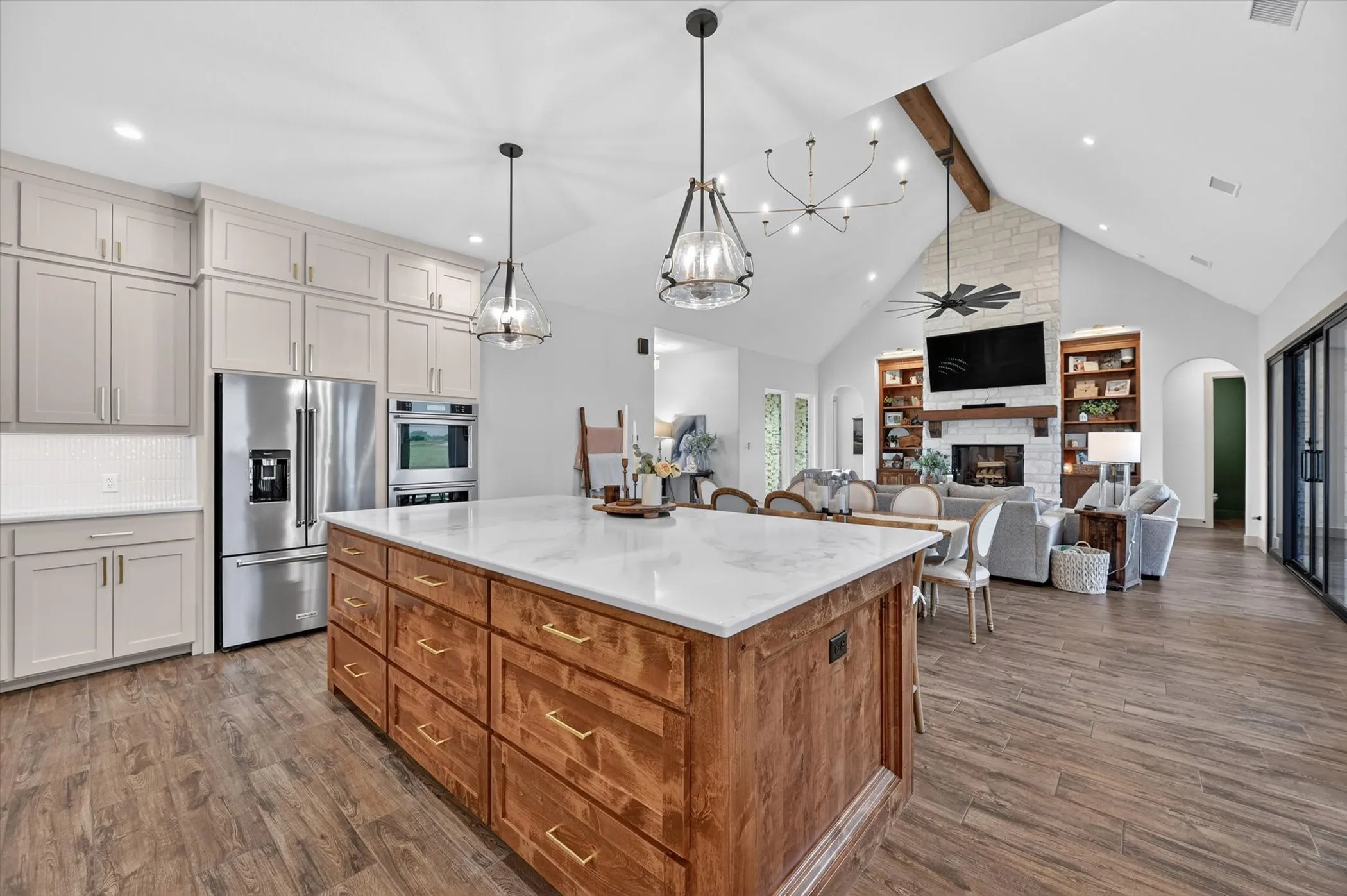 Gourmet kitchen island with wood-cabinetry and  stone countertop