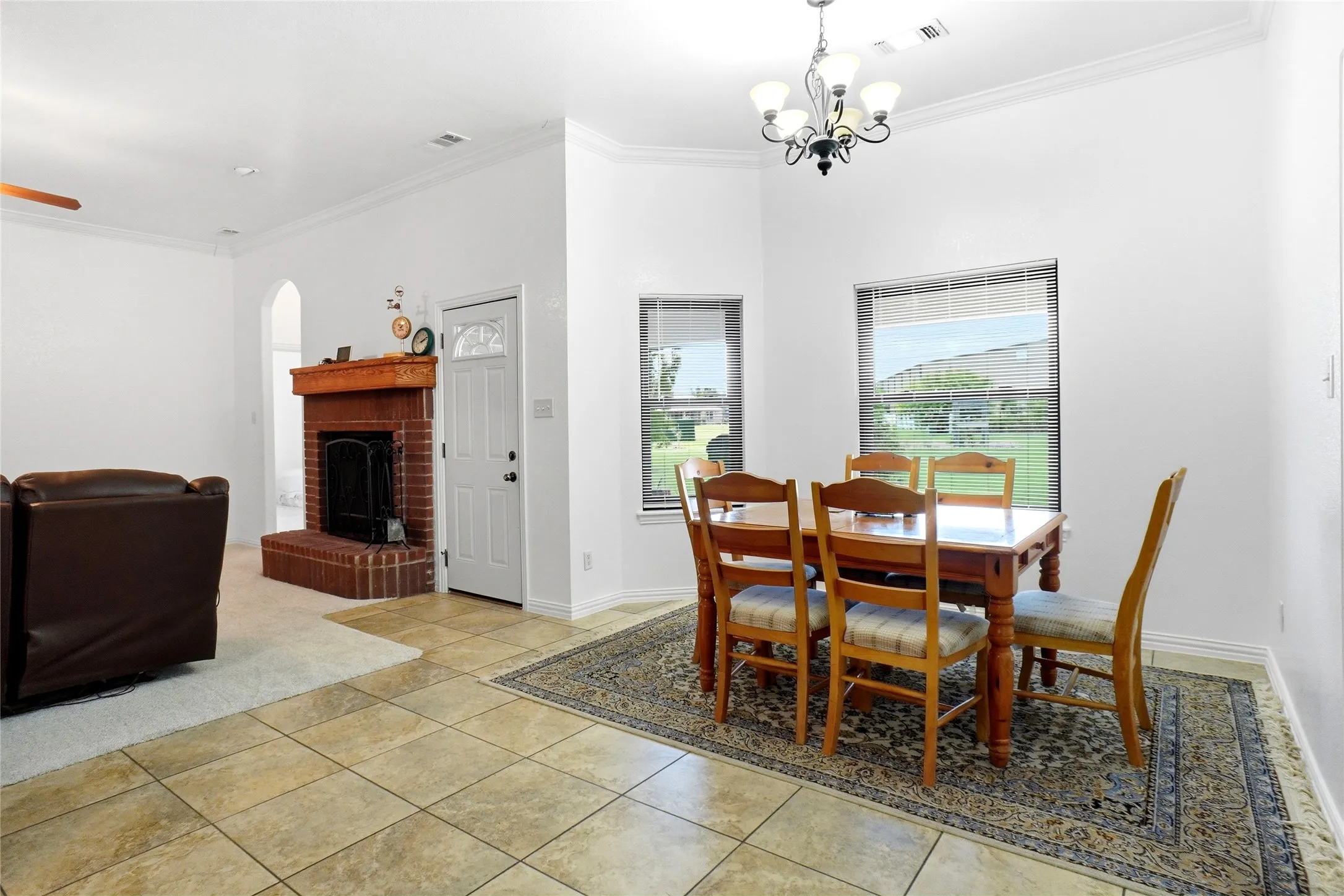 Dining area with ceramic tile flooring, a chandelier fixture, and multiple windows providing natural light