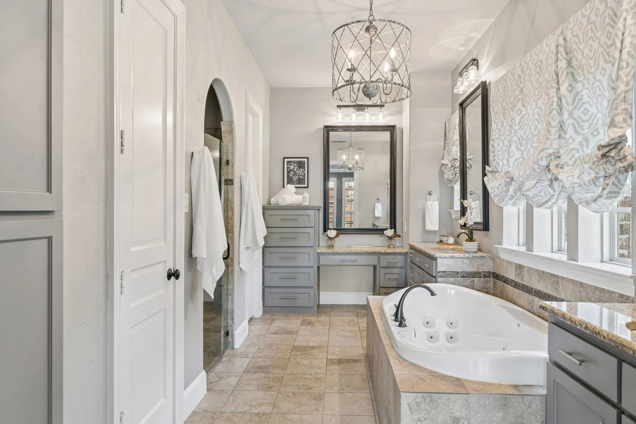 The owner's suite includes a luxurious ensuite featuring a soaking tub with multiple jets, flanked by dual vanities with granite countertops.