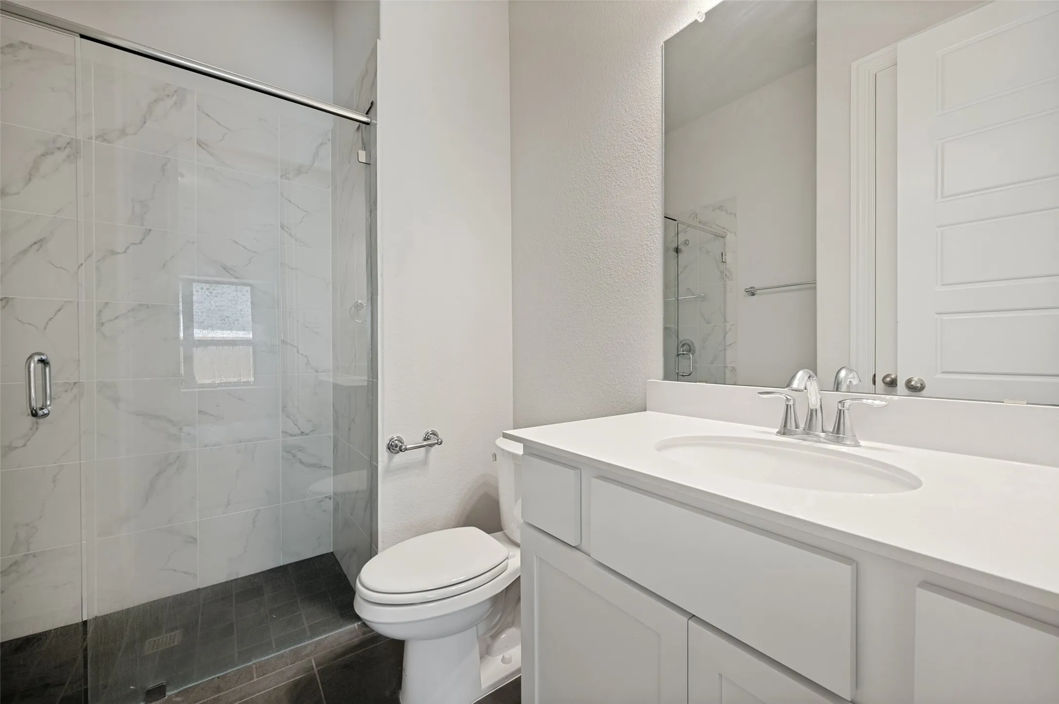 Private ensuite bath with quartz countertops, walk-in shower, and designer finishes.