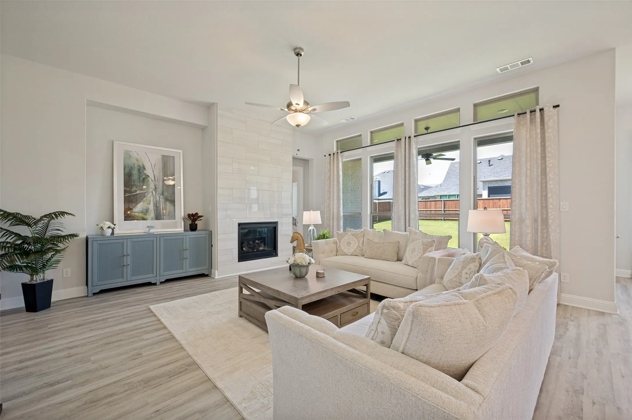 Enjoy effortless move-in-ready living in this light-filled family room, where expansive windows, stylish furnishings, and an open-concept design create the perfect space to relax and entertain. Even better, all living room furniture conveys with the home, offering exceptional value and convenience for the next owner
