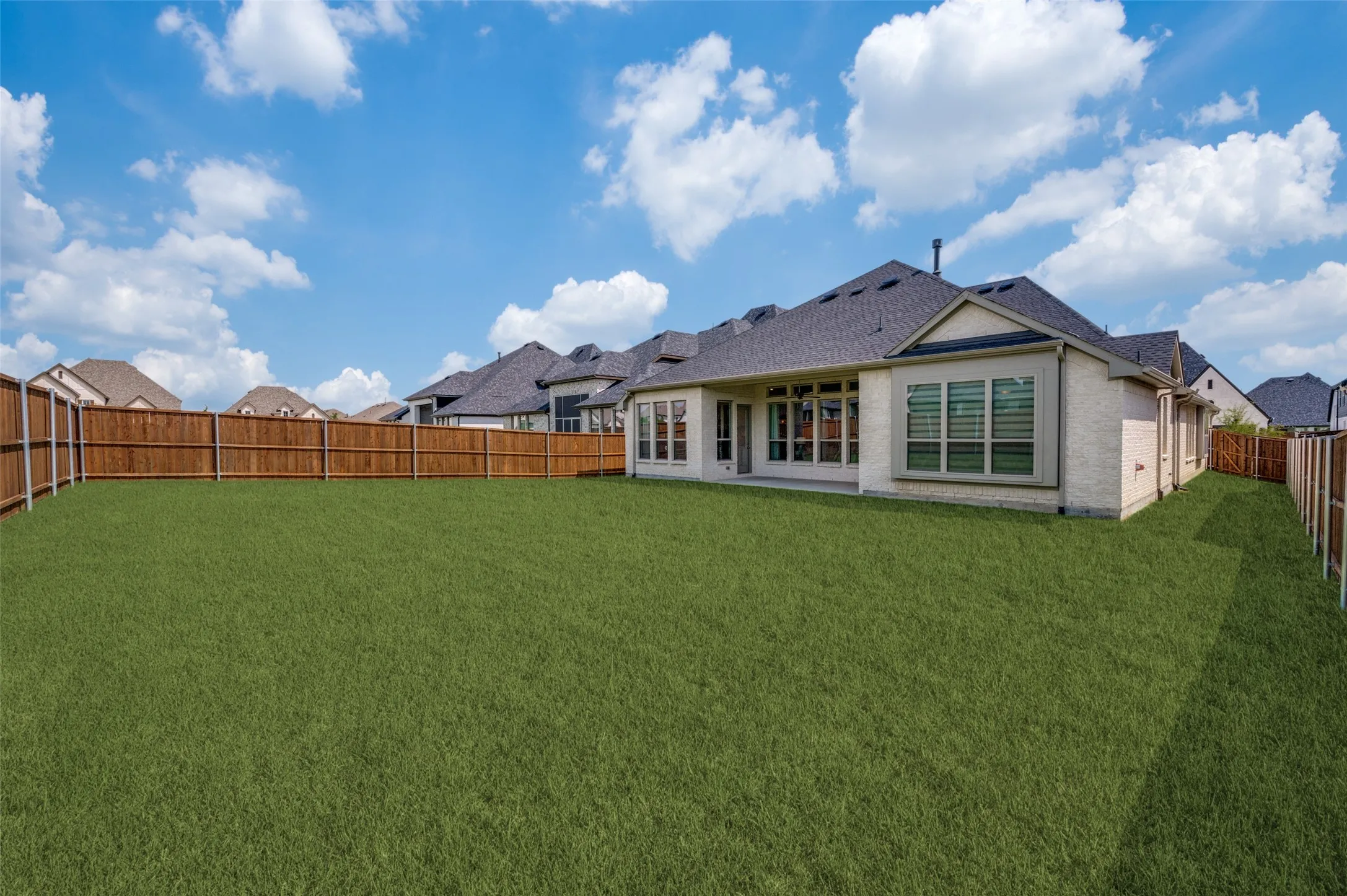 Enjoy endless possibilities in this oversized backyard, offering plenty of room to create the outdoor living space of your dreams. Situated on a desirable larger homesite, the fully fenced yard provides ample space for a future pool, outdoor kitchen, play area, or garden while still leaving room to entertain. The covered patio is perfect for relaxing with your morning coffee or hosting gatherings, making this backyard an ideal extension of the home's living space.