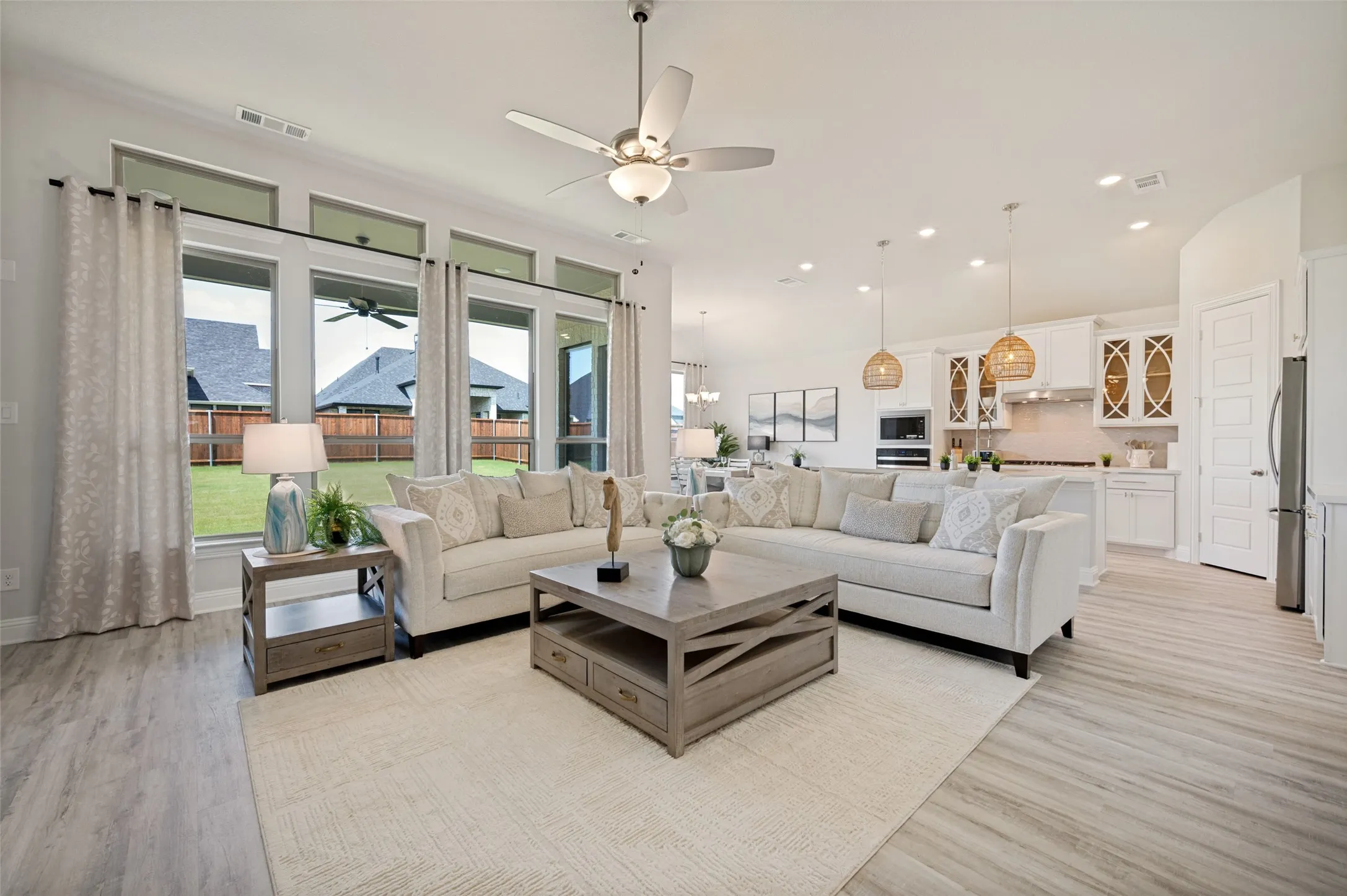 Bathed in natural light and thoughtfully designed for modern living, this expansive great room serves as the centerpiece of the home. Large picture windows showcase backyard views while the seamless connection to the kitchen and dining spaces creates an ideal environment for entertaining.