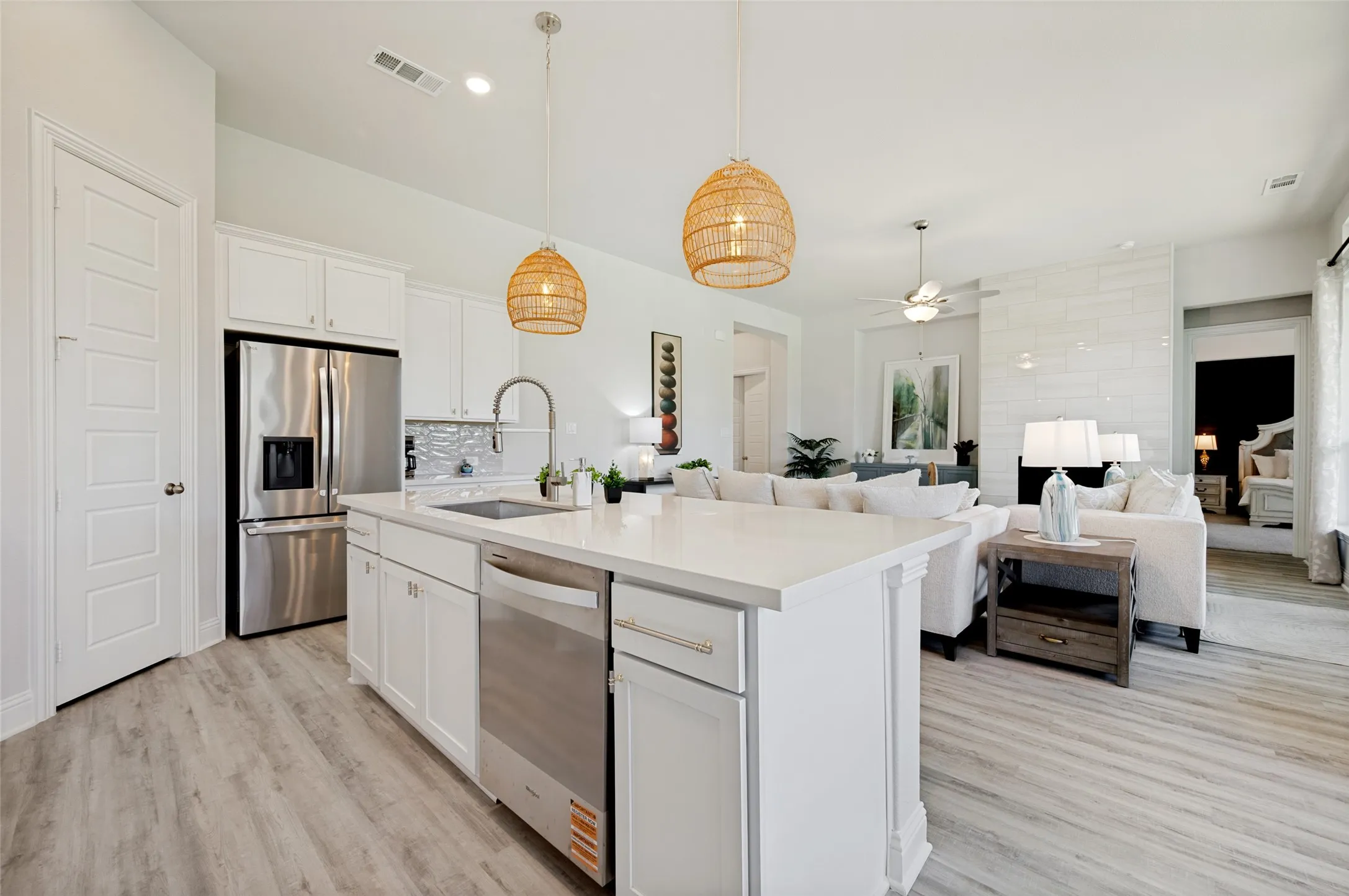 Designed to impress, this stunning gourmet kitchen showcases an oversized gathering island, quartz countertops, double ovens, stainless steel appliances, and custom cabinetry. Elegant pendant lighting and a seamless connection to the living and dining spaces create an exceptional environment for entertaining and everyday living alike