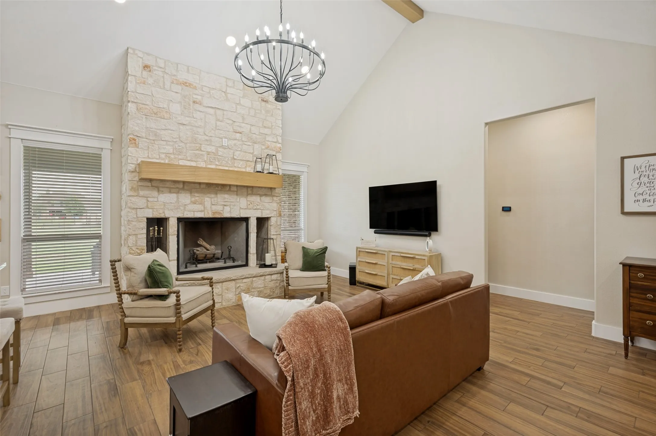 Showcasing the heart of the home, the stunning floor-to-ceiling stone fireplace creates a dramatic focal point in the living room. Topped with a substantial wood mantel and framed by soaring cathedral ceiling, this impressive feature adds warmth, character, and timeless elegance to the space.