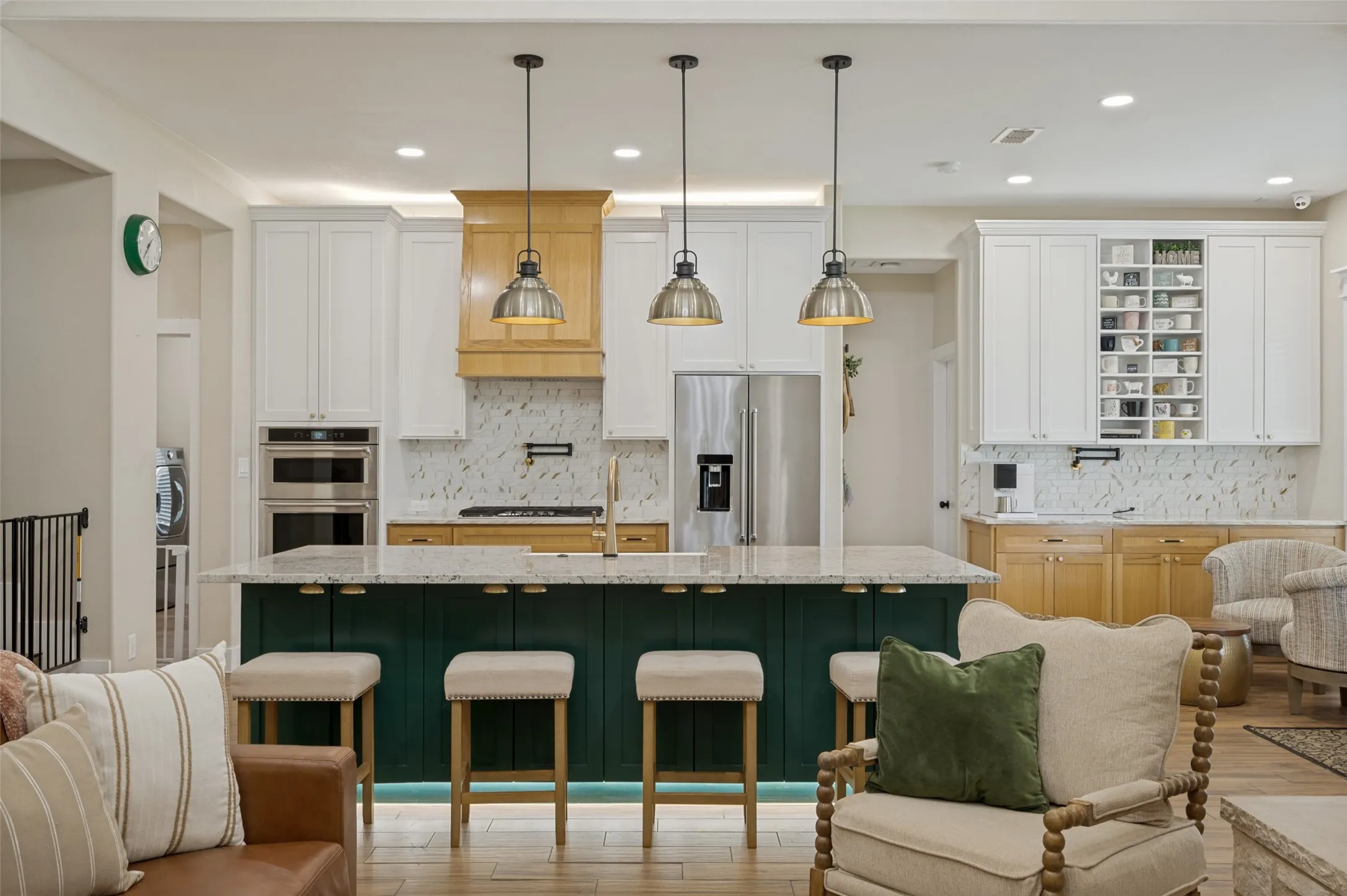 The kitchen is beautifully illuminated by a thoughtfully layered lighting design that enhances both style and functionality. The combination of ambient, task, and accent lighting creates a welcoming atmosphere that feels both sophisticated and comfortable, day or night.