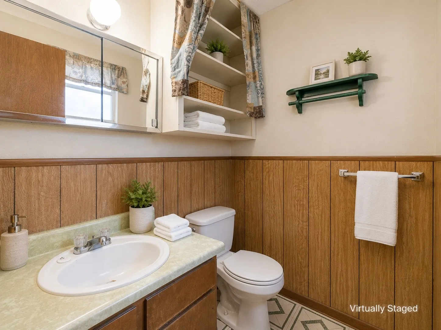 Bathroom featuring wood-paneled wainscoting, an integrated sink vanity with a light-colored countertop, and a built-in medicine cabinet with mirrored doors