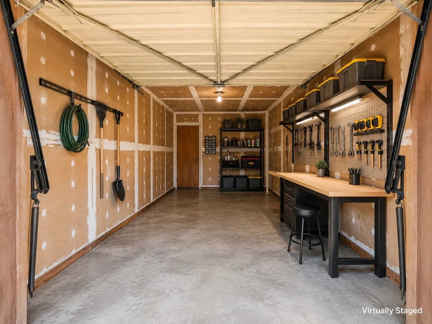 Spacious garage with concrete flooring, exposed wall studs, and overhead lighting