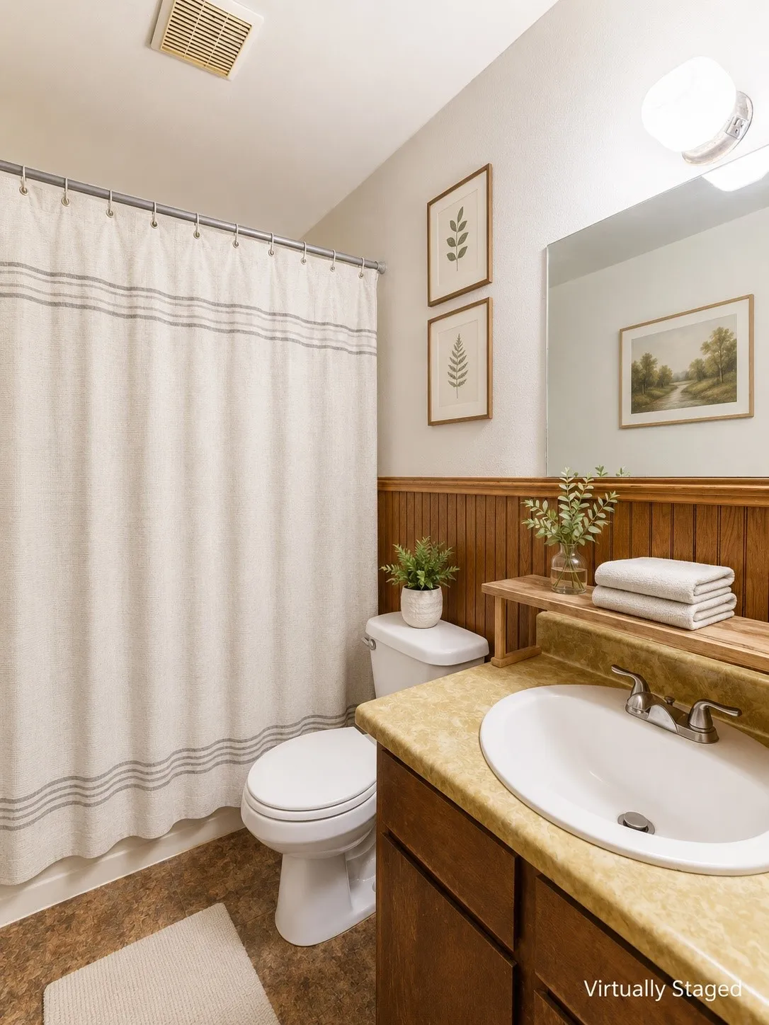 Full bathroom featuring a single vanity with an integrated sink, a built-in mirror, wood paneling, and wood-finish flooring