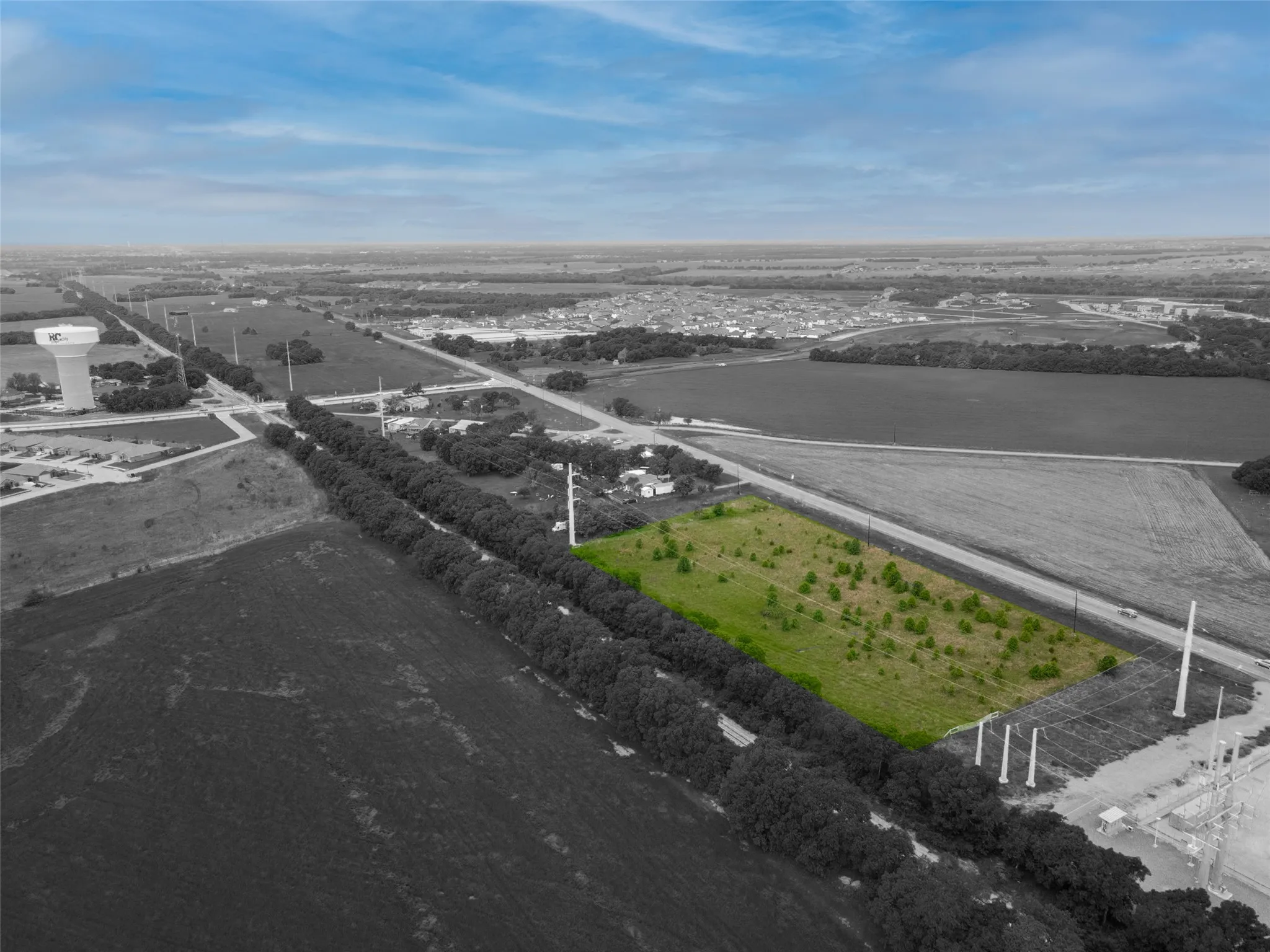 Expansive parcel of undeveloped land featuring varied terrain and scattered young trees
