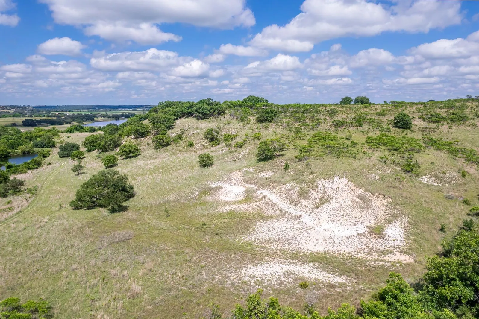 Expansive landscape featuring rolling hills and abundant natural vegetation