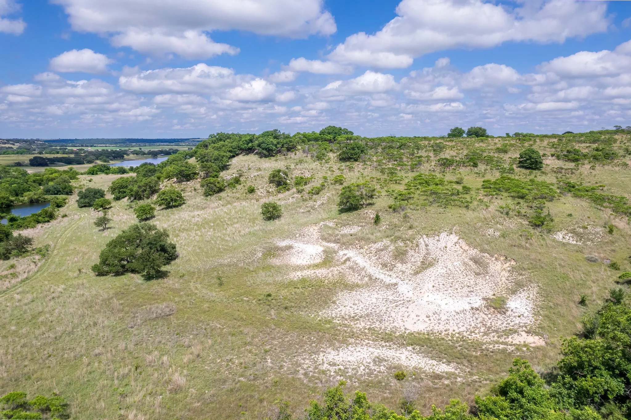 Expansive natural landscape featuring rolling hills and varied topography