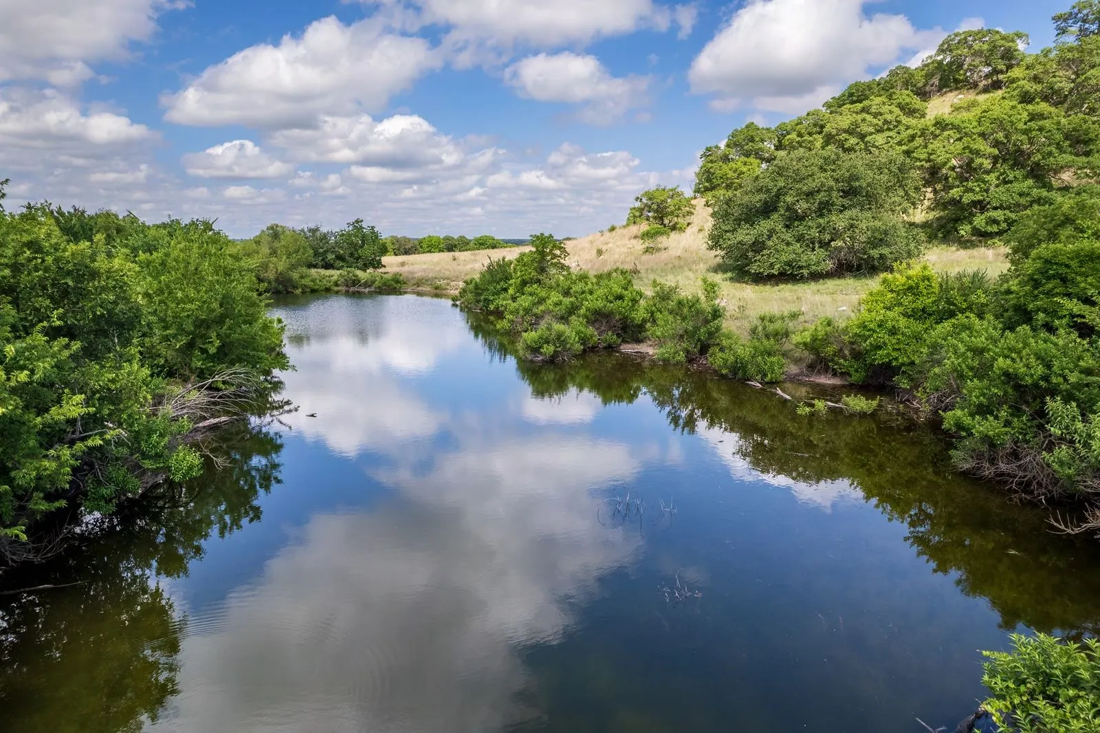 Natural body of water reflecting a partly cloudy sky