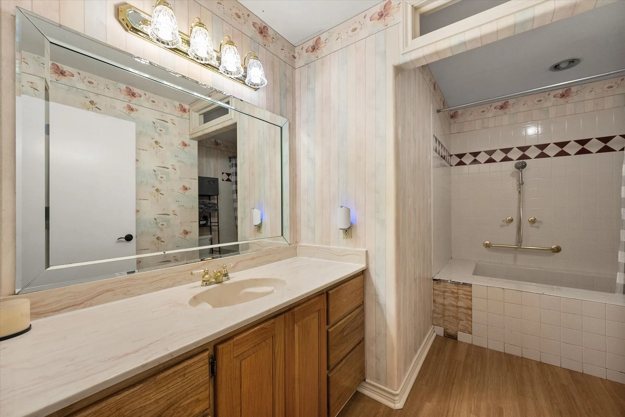 Full bathroom with oversized vanity and convenient layout.