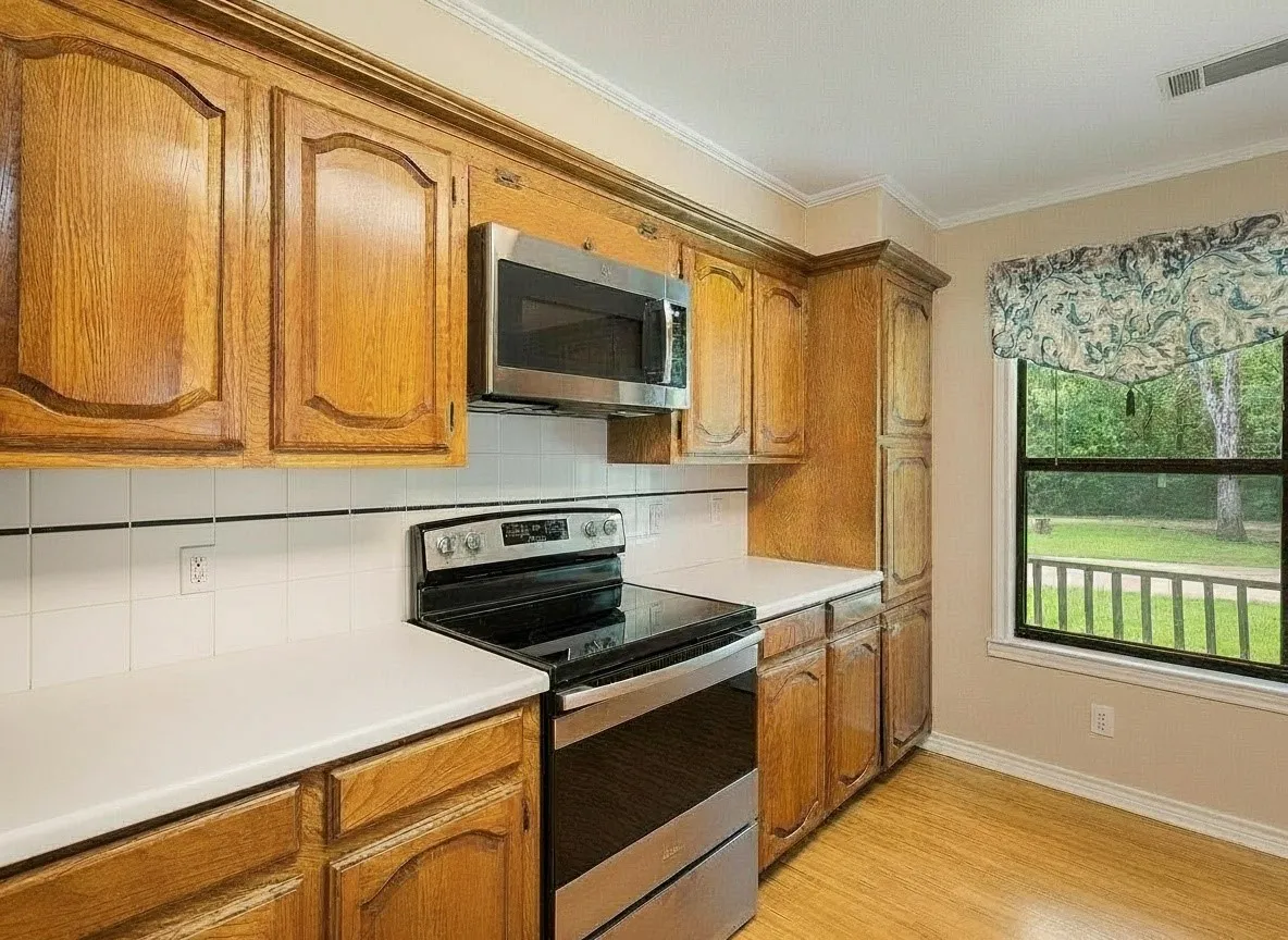 Bright kitchen with extensive cabinet storage and durable workspace.