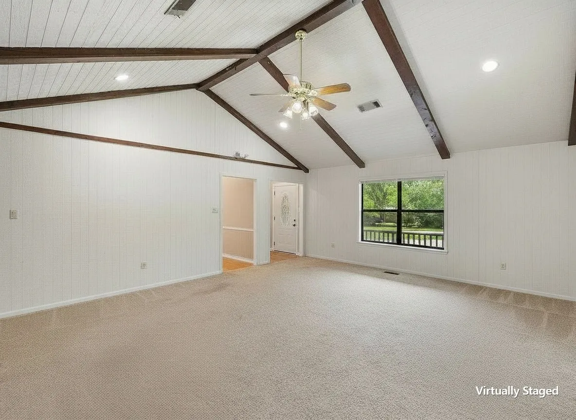 Spacious living room ready for your vision with soaring vaulted ceilings and abundant natural light.