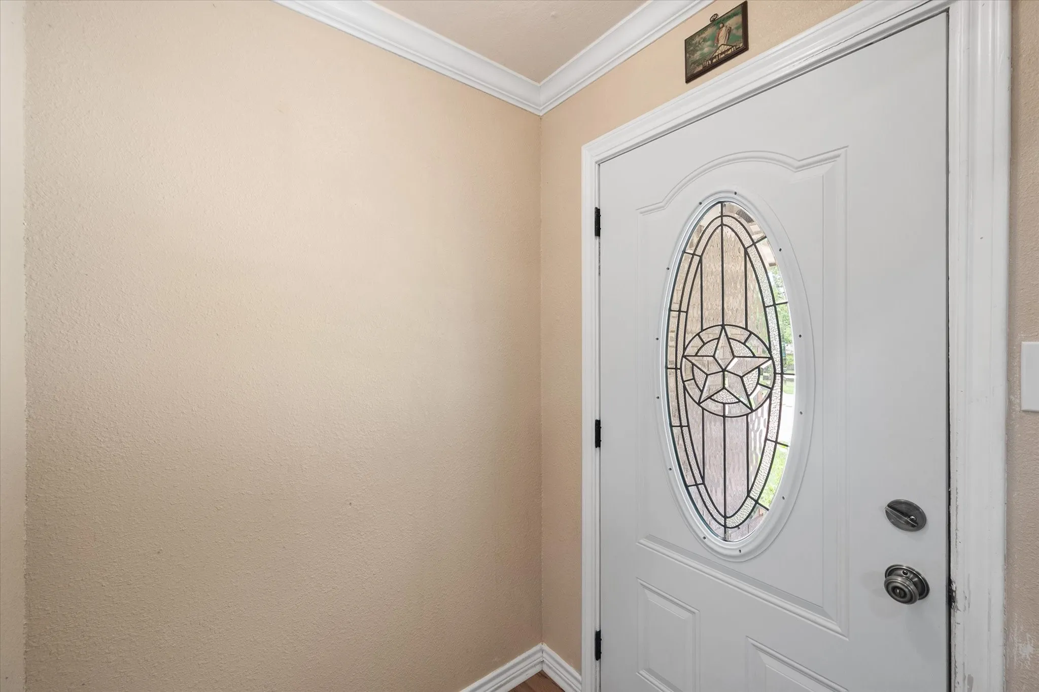 Welcoming front foyer with decorative glass entry door.