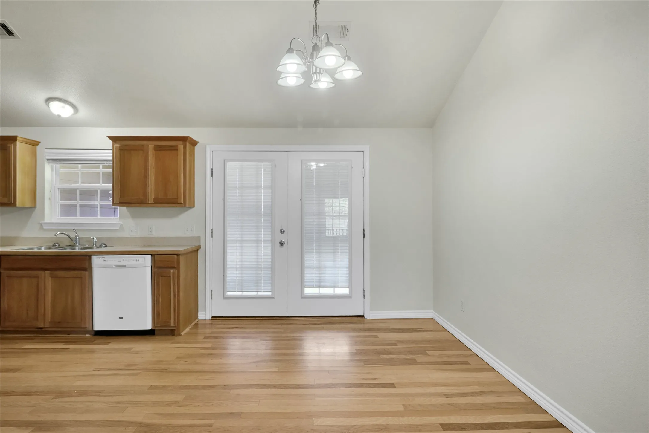 Kitchen and dining area featuring wood-finish flooring