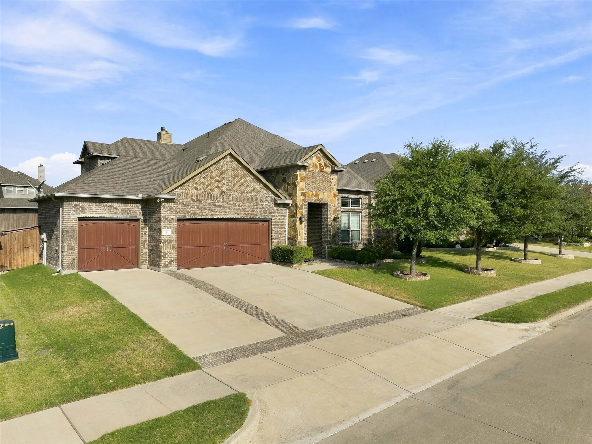 Striking stone and brick exterior with a steeply pitched roof and multiple gables