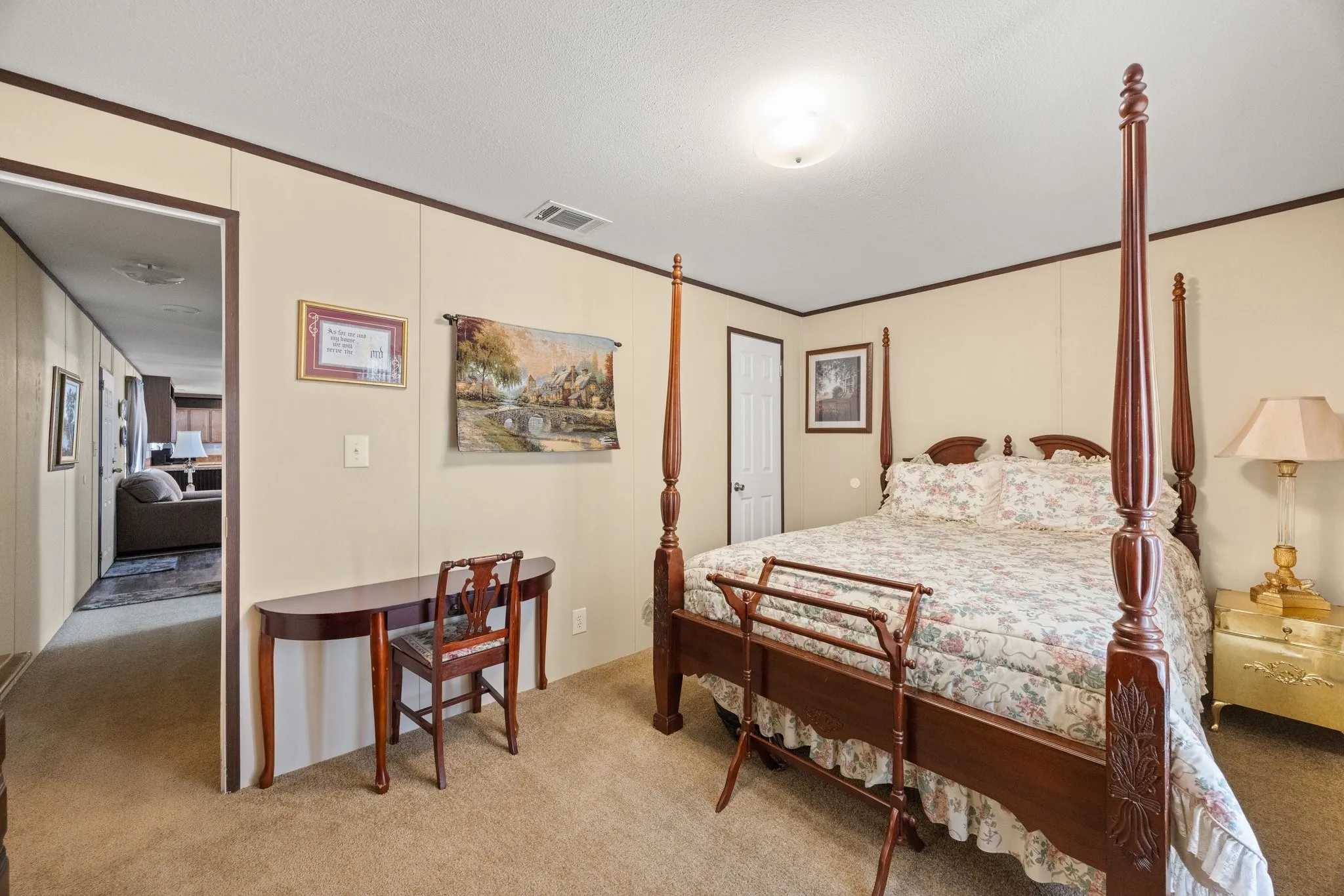Carpeted bedroom with a built-in ceiling light fixture, neutral wall finishes, and dark trim details