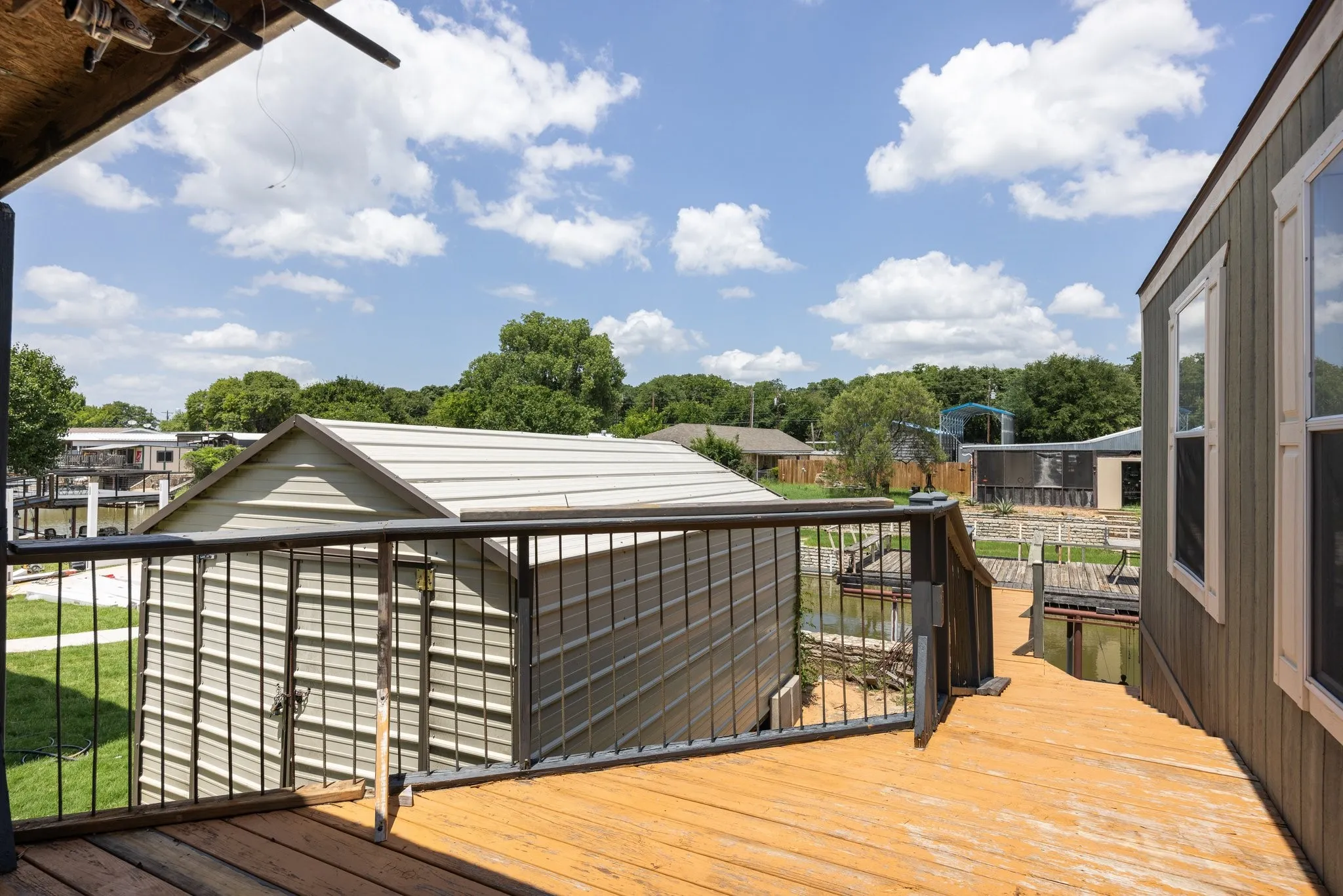 Outdoor deck with wood-finish flooring and black metal railings
