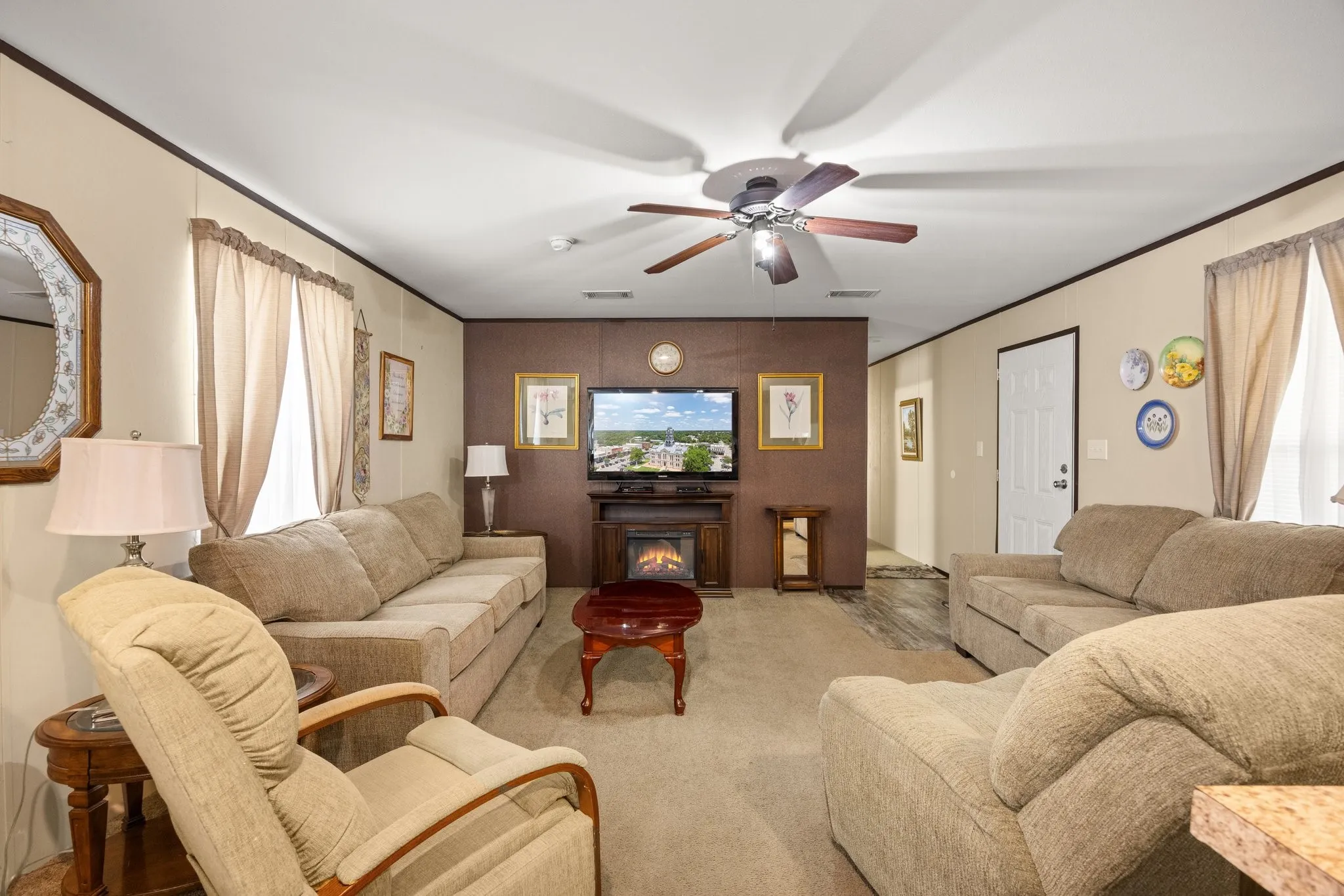 Inviting living area featuring a ceiling fan, recessed lighting, and a neutral color palette
